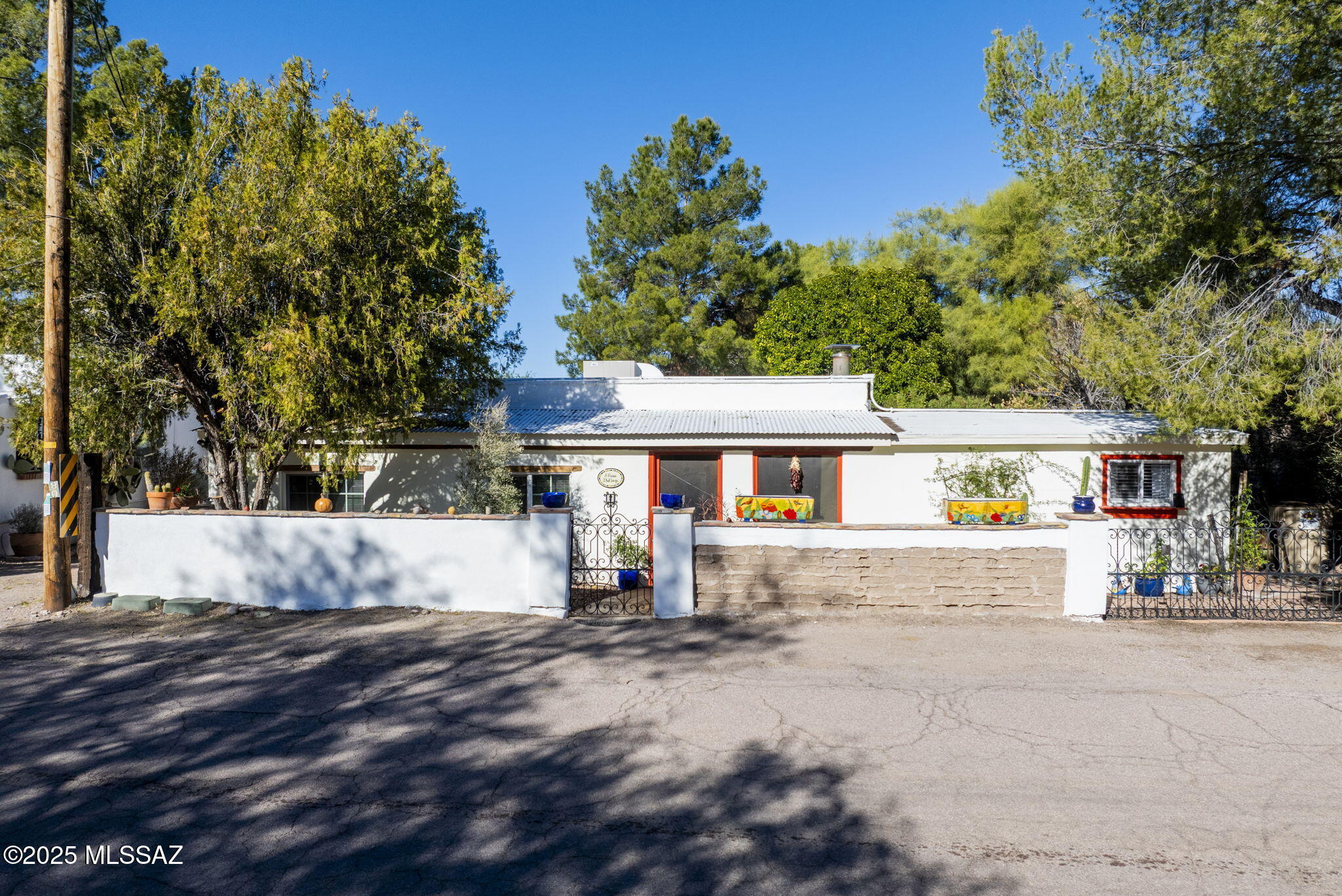 Perfect home for you or for a VRBO.  The ''House That Sings' is one of the most beloved original adobes in Tubac, located in the historic area of the village.  This heritage home has been completely updated while still retaining the character that makes it so very charming.  Three bedrooms, or two with a den, porch area used as an office, 2 bathrooms, & updated kitchen.  Saltillo tiles throughout.  Large shower with an exotic wood counter featuring 2 copper sinks in the main bathroom.  The second bathroom has a claw foot soaking tub with shower. The stunning outdoor paved and walled living area reflects both a lot of love and a fantastic green thumb with fruit trees, roses & a herb garden. There is an Artist or Ceramic Studio & Workshop too!
