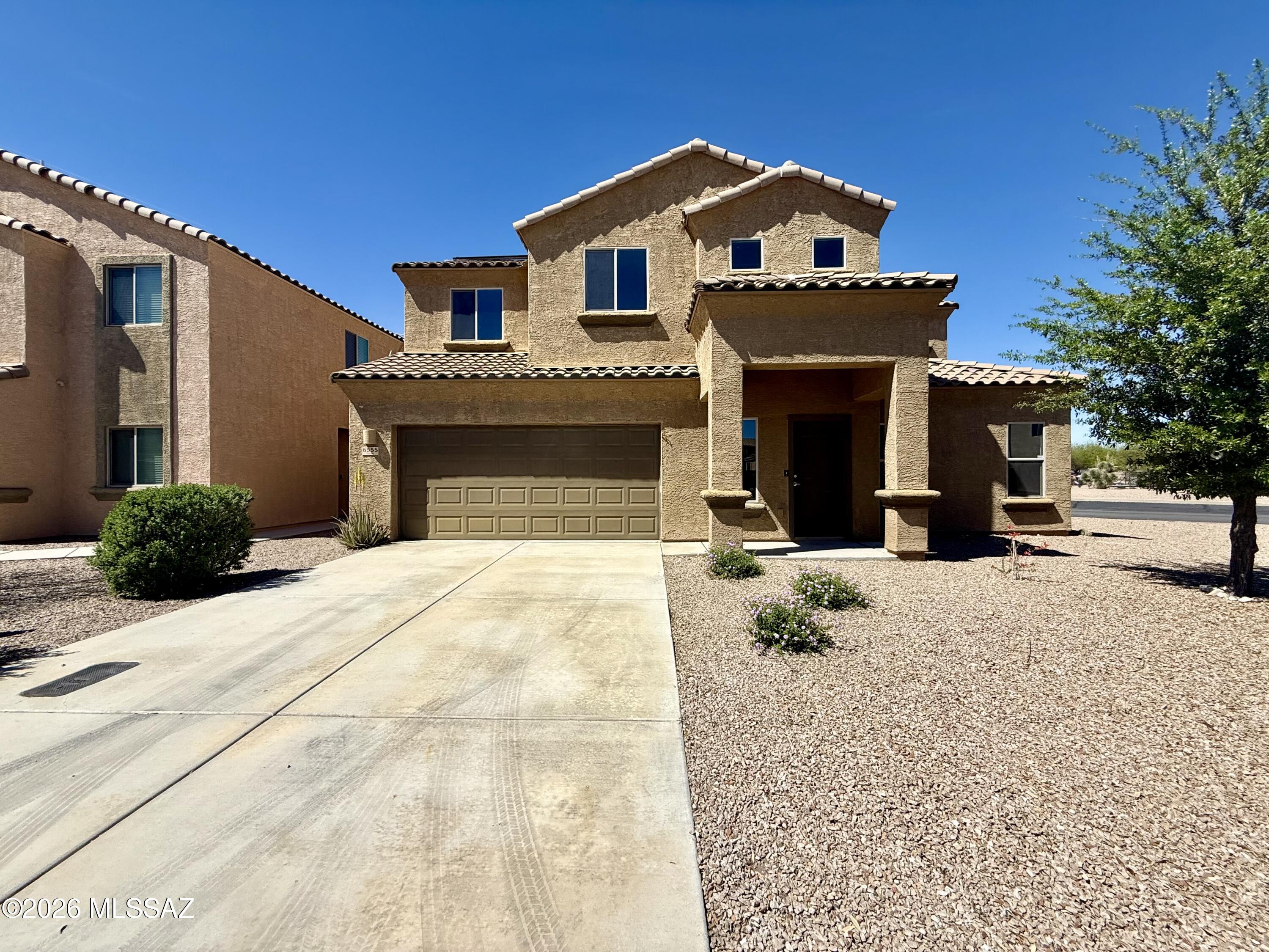 This spacious 1,632 square foot two-story home features 3 bedrooms and 2.5 bathrooms in the desirable Vista Montana Estates neighborhood. The well-appointed kitchen with granite countertops includes modern appliances such as a dishwasher, microwave, oven, refrigerator, and convenient water RO system for clean drinking water. The open living areas showcase a comfortable blend of carpet and tile flooring throughout, creating distinct zones while maintaining flow between spaces. The home offers excellent storage and convenience with a dedicated laundry room featuring an in-unit washer and dryer. The primary bedroom includes a spacious walk-in closet for ample storage, while the additional bedrooms provide flexibility for family, guests, or home office space. All three full bathrooms ensure convenience for larger households or entertaining. The attached 2-car garage provides secure parking and additional storage space, mini split to help cool, complete with a garage door opener for easy access. Outside, the fully fenced yard offers privacy and security, perfect for relaxation or outdoor activities. Solar paneling will help with the hot summers. Located across the street from community center which features a pool and fitness center. Located in Vista Montana Estates, residents enjoy a peaceful residential setting while maintaining convenient access to Tucson's shopping, dining, and recreational opportunities.