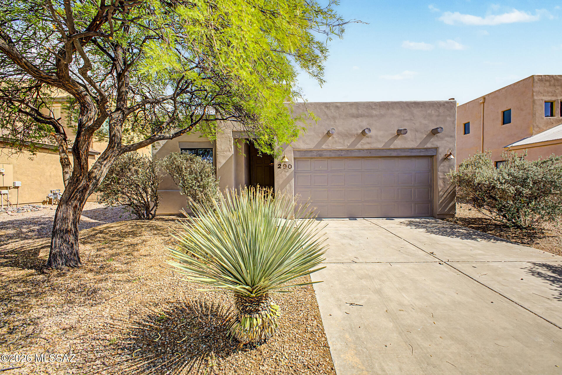 Santa Fe style charm meets modern comfort in this 4 bedroom, 3 bath home in Corona De Tucson, within the Vail School District. Recently refreshed with interior and exterior paint and updated lighting, this home offers tile flooring throughout--no carpet. The split floor plan features two spacious primary suites, plus two guest bedrooms connected by a Jack and Jill bath. The open great room boasts plantation shutters and a cozy fireplace, creating an inviting space for gathering. Step outside to the covered patio and enjoy a low-maintenance backyard, perfect for relaxing or entertaining.