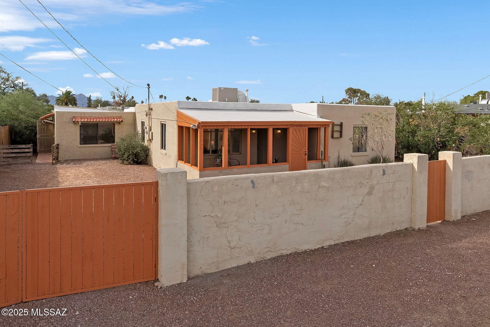Discover this versatile home with attached guest house in a convenient central Tucson location. The main house offers 3 bedrooms and 2 bathrooms, with tile floors throughout. The third bedroom (currently used as a den) is ideal for a home office or flex space. The guest house features 1 bedroom and 1 bathroom with an inviting open floor plan, exposed beams, and a spacious bedroom. A great opportunity for multi-generational living or rental income. Enjoy the fully enclosed yard with a large double gate, allowing cars to be tucked securely off the street. Situated close to shopping, restaurants, and walking distance to the public library.