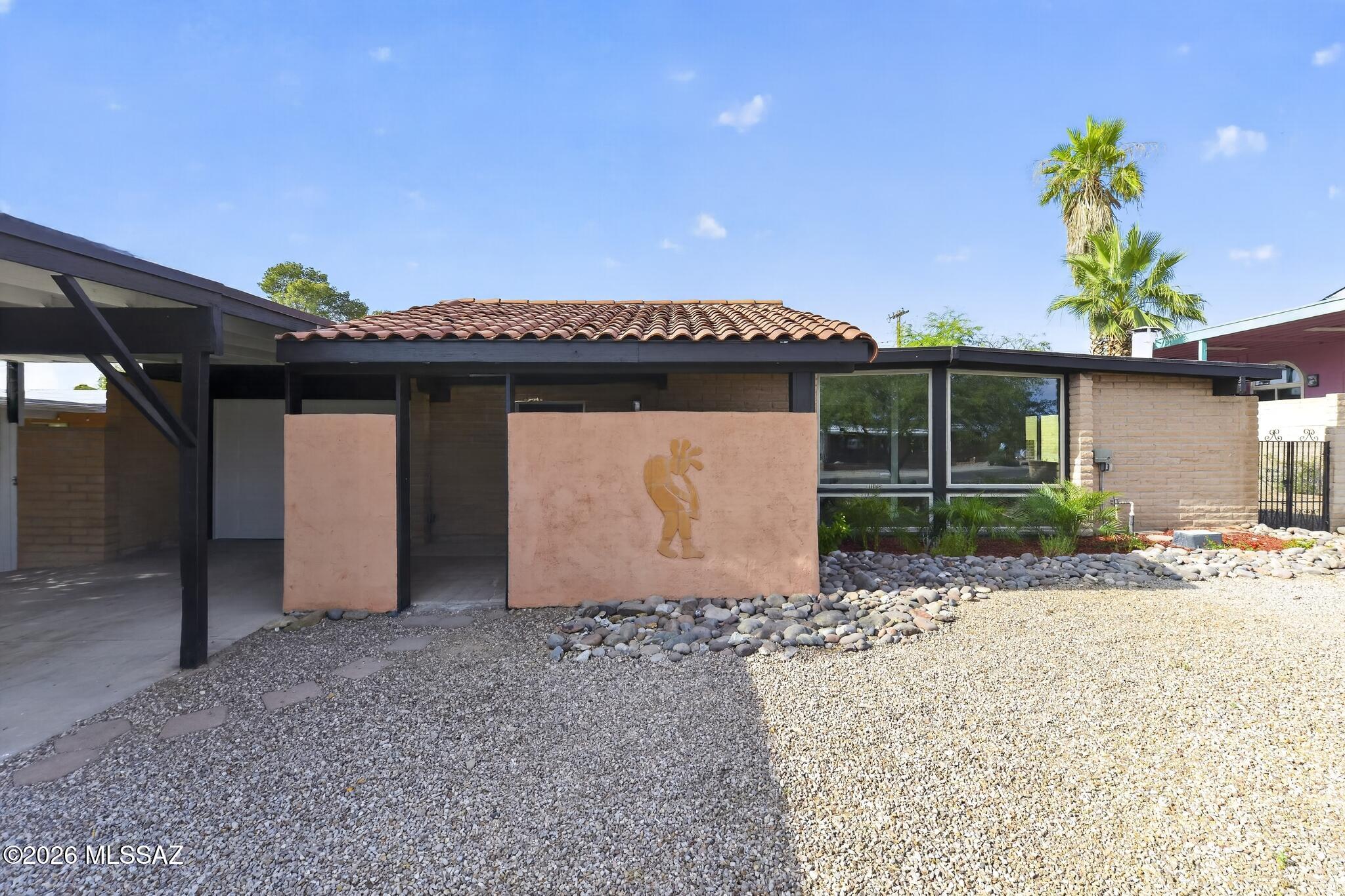 A rare opportunity in Ironwood Hills, a quiet, established neighborhood where homes seldom come up for sale, especially with a pool. This updated mid-century block home centers on a deep diving pool, newly resurfaced in Pebble Tec, set on a paver and cool-deck patio inside a block-walled yard with a covered patio and new low-water plantings already set up on drip irrigation. Inside, the remodeled kitchen pairs granite counters and knotty alder cabinetry with open shelving, a breakfast bar, and stainless appliances, including a 5-burner gas range. New luxury vinyl plank flooring in the living spaces, with easy-to-clean slate-look tile in the kitchen and hall. Updated bathrooms and finishes throughout, including large built-in storage closets, new carpet in the bedrooms, and fresh paint. This home is ready for move-in! Added touches include a finished workshop space for projects inside and a pergola with hot tub outside. Owner/Agent.