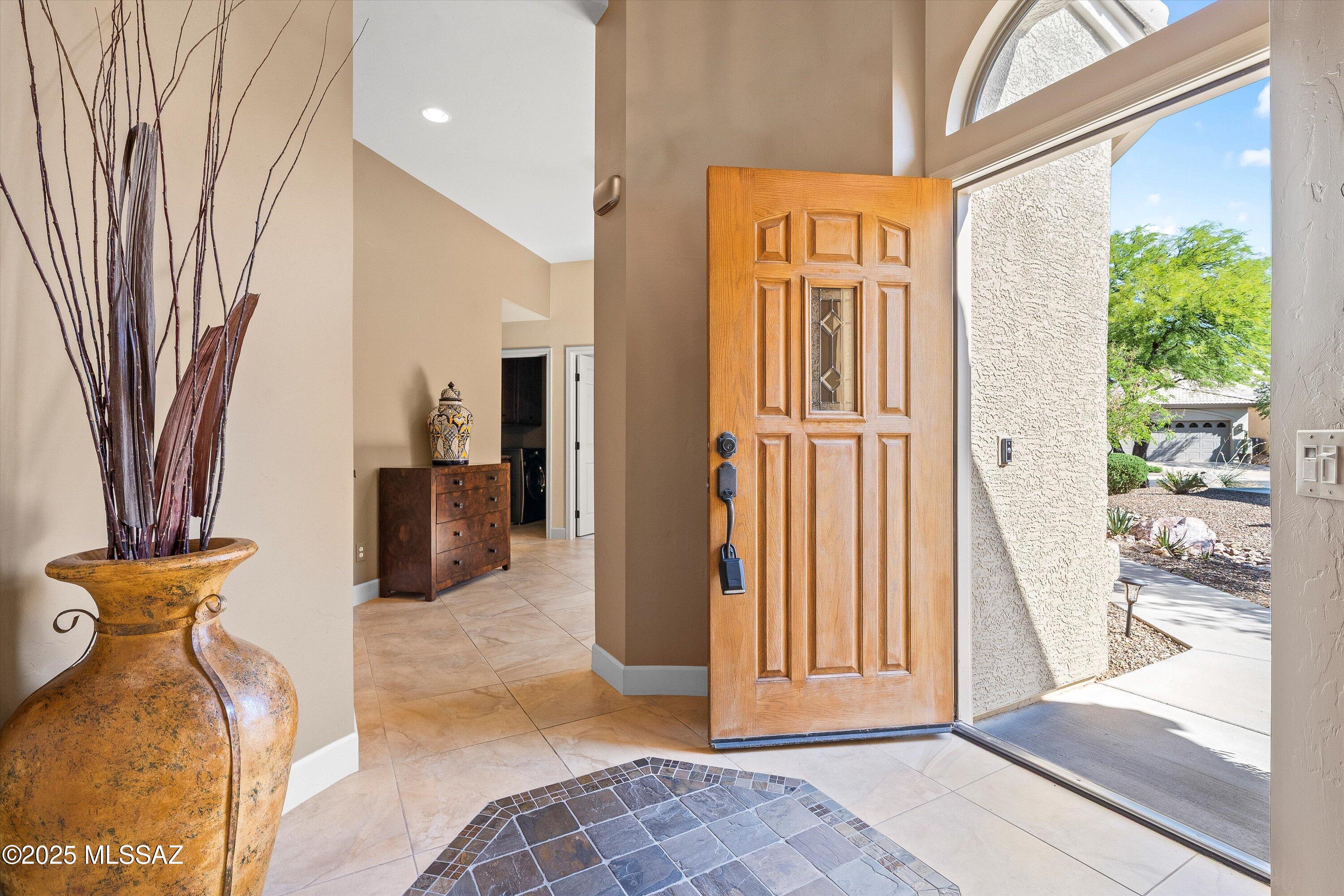Catalina Mountain views from this gorgeous Verona model Villa. Designer touches include a slate gas fireplace, porcelain tile, kitchen with granite counters, ss appliances included. Large picture windows with built in UV protection flood the kitchen and breakfast nook with natural light. Primary suite has large slider leading to the backyard, remodeled bathroom and custom closet. Guest bedroom features murphy bed. Tranquil outdoor setting with extended brick paver patio, auto sun shade & breathtaking desert and mountain views. Epoxy-finished 2-car garage, sensor lighting, newer HVAC & water heater and whole house filtration system. HOA covers exterior maintenance.Saddlebrooke offers including golf, pickleball, tennis, pools, restaurants, fitness, clubs and more.