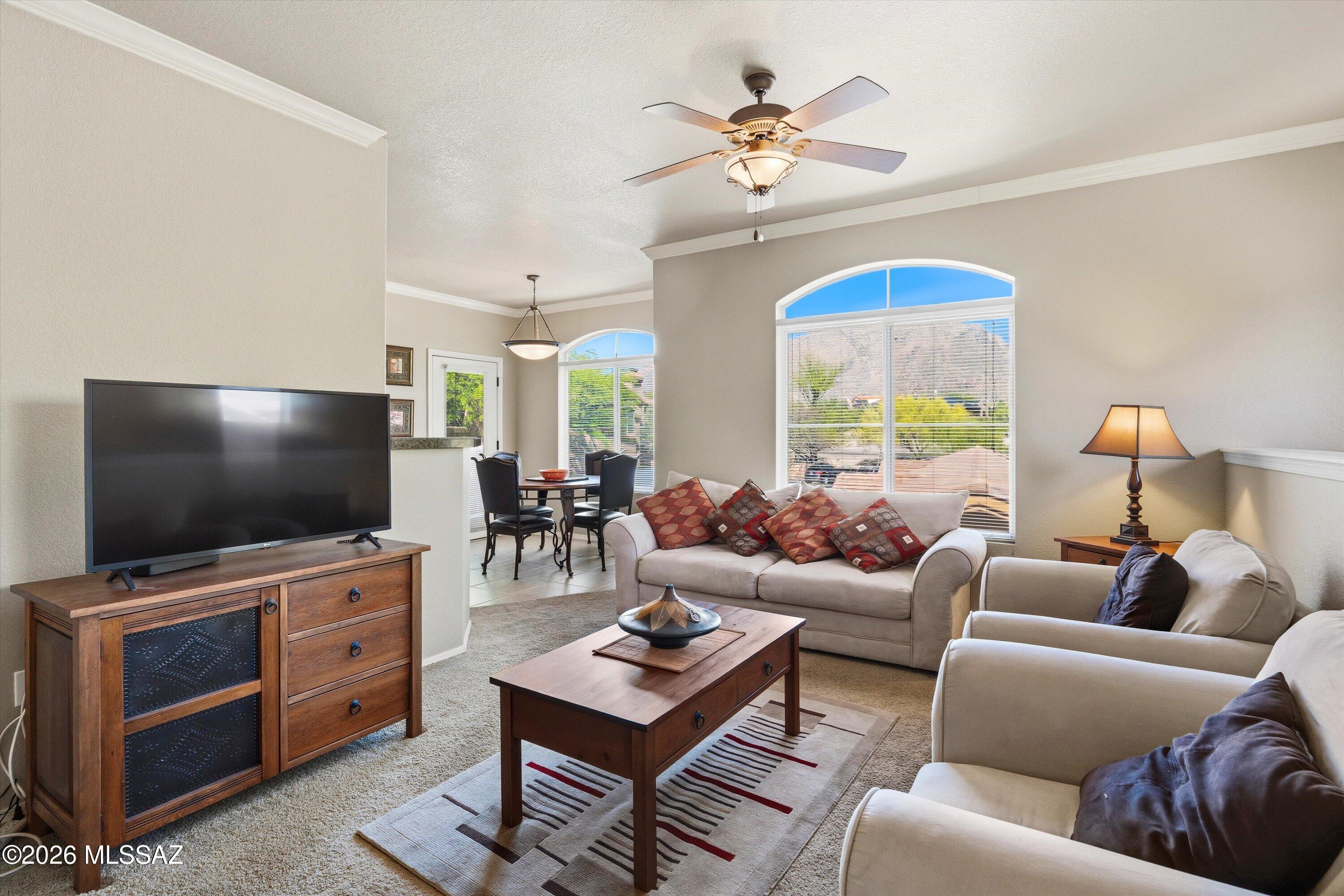 Experience elevated low-care desert living in this spacious second floor corner unit condo with breathtaking mountain views in the gated Catalina Foothills community of the Pinnacle Canyon Condos.  This luxury Northern Tucson condo is being sold fully furnished & features an expansive open concept split bedroom floorplan with an abundance of natural light, kitchen with stainless steel appliances & granite counters, private primary bedroom with roomy walk-in closet, covered North facing balcony with Catalina Mountain views and a convenient location across the street from shopping & numerous restaurants and just down the street from Sabino Canyon Park. The Pinnacle Canyon Condos amenities include a heated pool & spa, clubhouse with gym, WiFi, on site manager, BBQ grills & park-like grounds.