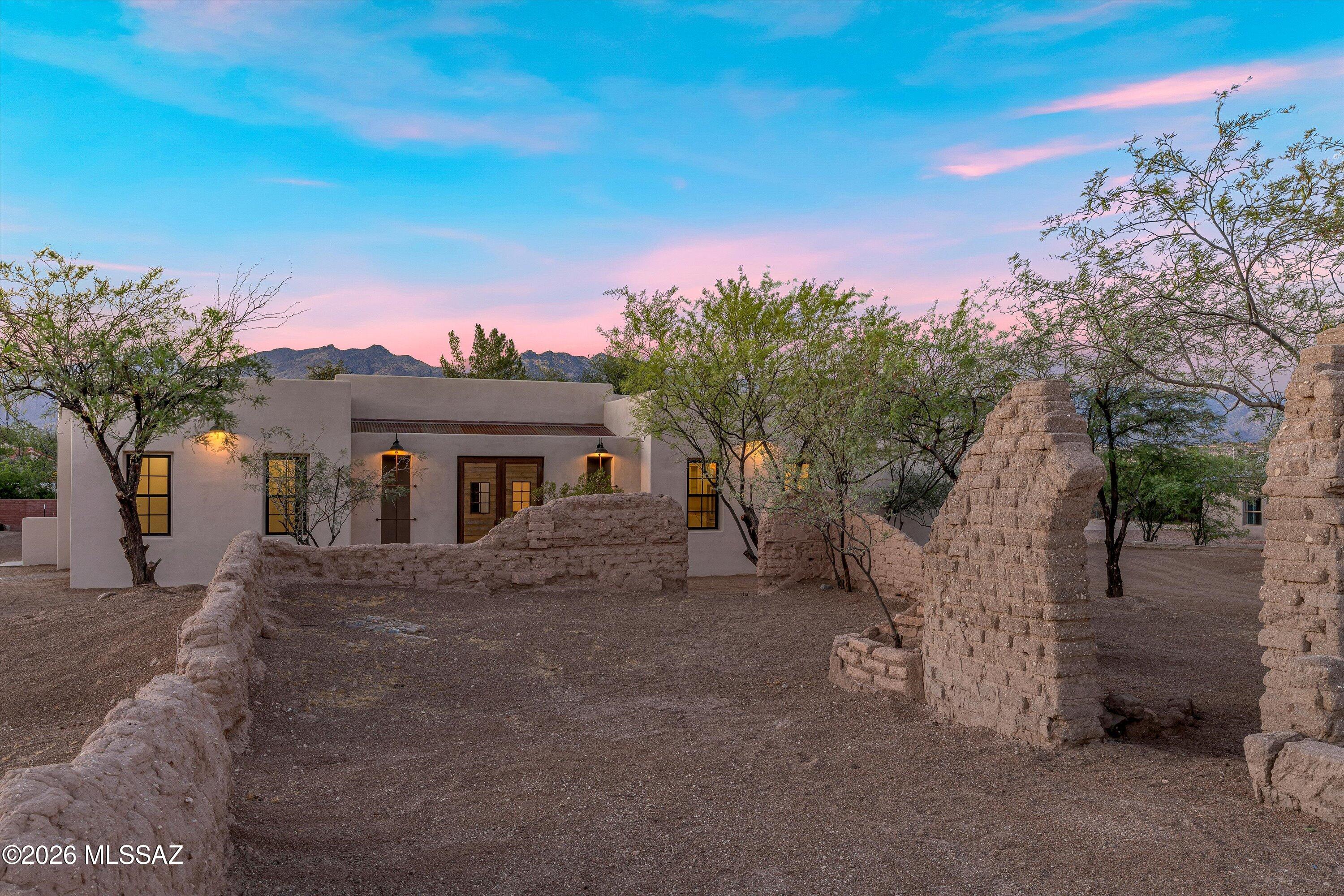 Tucked away just rear of the existing 1908 old adobe School House ruins and sun-dried adobe brick walls that sit gently north and west of the property, this beautiful newly constructed home reflects the lands rich preserved history in Tucson's Old Fort Lowell Historic Neighborhood. As you step onto the property you're taken back to the village of El Fuerte, aka ''The Fort'', where the Old School House was built for the children of the community, across the street enjoy views & a short walk to the Historic San Pedro Chapel. A unique and rare preserved piece of history that welcomes you day to day with serene desert living beauty & relaxation. 9-10 ft ceilings, modern open concept living, gorgeous kitchen with waterfall island, elegant quartz countertops, plentiful cabinetry, a spacious walk-in pantry, rustic wood beams, and a courtyard pool, all so perfect for family gatherings & entertaining. Each ensuite shows attention to design work & detail providing comfort, privacy & space for all. Study/office offers flexibility to work from home or use as a creative bonus room. Exceptional craftsmanship throughout shows the dedication, time & commitment in the design build of this beautiful new home, in keeping with timeless preserved historical significance this property holds, a true rich value in itself. Seller licensed to buy/sell real estate in state of AZ, Owner/Agent; Listing Agent has a financial interest in property, treat as Owner/Agent. Please do not enter historic adobe ruins.