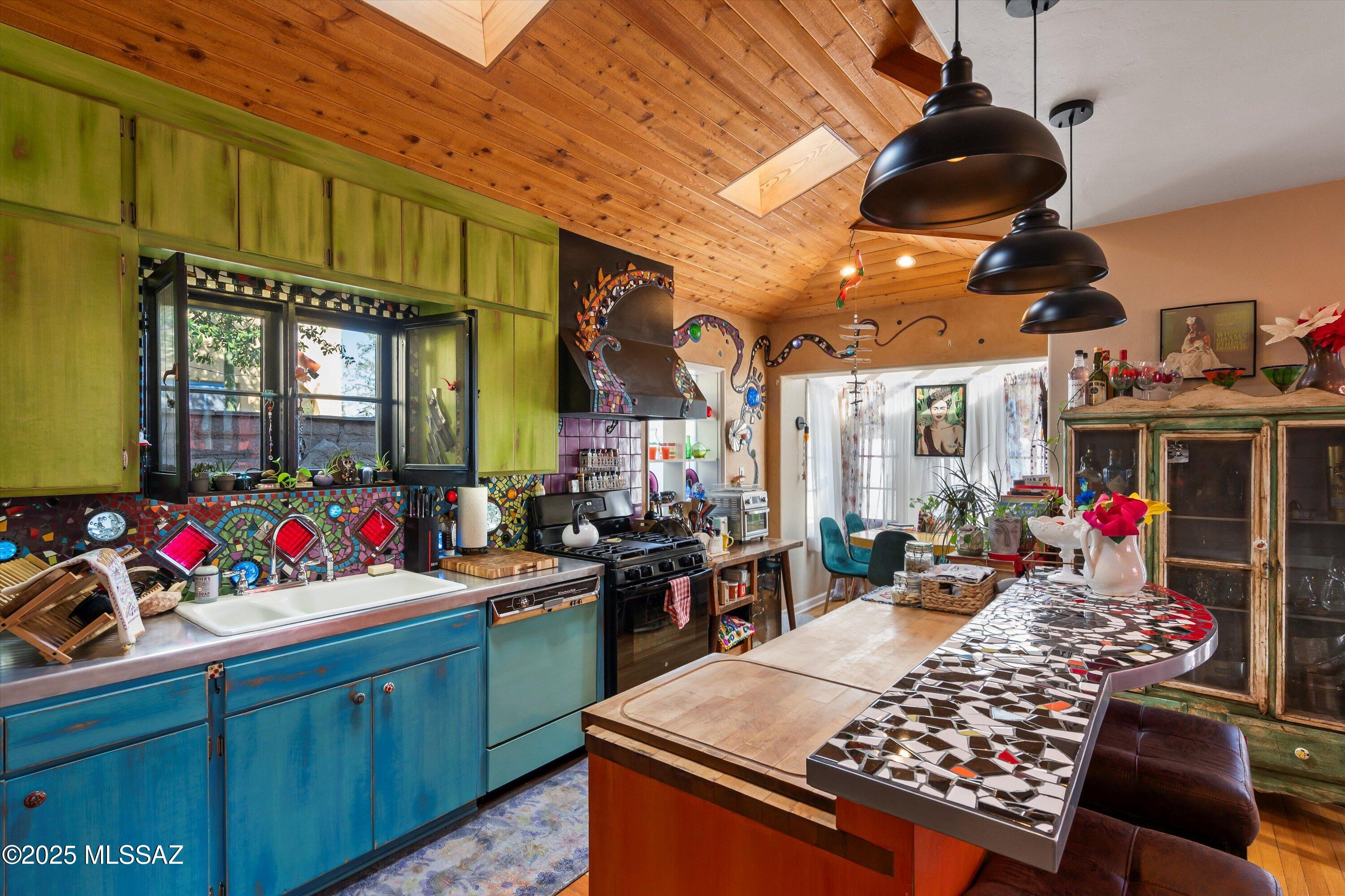 Seller will accept or counter offers between $680,000 and $695,000. An eclectic oasis in the heart of desirable Sam Hughes neighborhood, two blocks from the UofA main campus, close to amazing restaurants, shopping, activities, yet safely patrolled by campus police. This home has historical tax status reducing taxes. The enchanting jewel tones used throughout the home highlight the custom glass and tile mosaic work completed by a UofA art student. Every room has niches and nostalgic touches to explore, including vintage glass doorknobs, historic windows, French doors, wooden ceilings in kitchen and bedroom! The entire property is fully fenced for privacy and has space enough for a pool or water feature, which the seller has plans and permits drawn up and PAID FOR. The back patio holds lots of mature plantings, an orange tree, an above-ground spa, an infrared sauna, and a newer stacking washer-dryer which convey with the property. There are 2 double gates to the property allowing for RV, boat, toy parking, gravel-paved driveway. A 2-car garage with a full wall of glass windows makes an amazing art studio. It also has plans and permits drawn up and paid for, to build an ADU or casita above the garage. Many upgrades including newer HVAC unit. See attached list for all upgrades and updates.
Comments from the owners: When people enter our house the first thing they say is "Wow". Probably because of all the color but the best reaction we ever got was "this looks like a Happy House". I loved it because that was my first reaction too. I have a theory about being attracted to so much color. We're from northern CA and there is so much green, and flowers grow profusely, so while I've been in AZ I love brightly painted walls and furniture and everything bright because I miss the color. If you like gray and neutral, this house is probably not your thing, but it could be toned down, I guess. We love this house but have decided to move closer to our kids. It was a hard decision because we love Tucson and have been here for over 25 years. We'd love for someone to enjoy our house as much as we have.