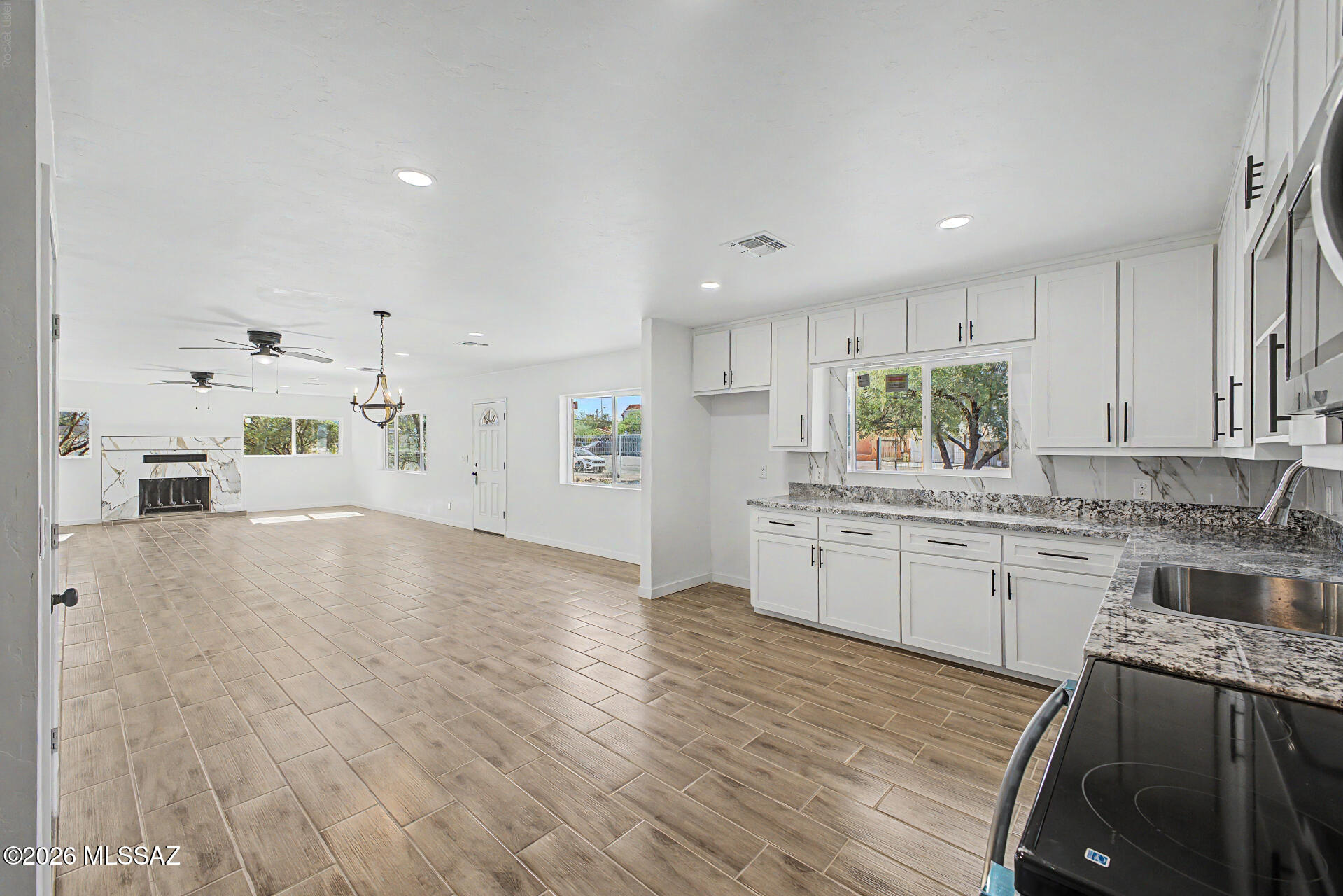 Discover this gorgeous fully remodeled single-story home with casita! FULLY REMODELED! Fenced front yard with RV gates! Inside, you'll find an inviting great room filled with natural light, featuring tile floors, contemporary lighting, a fireplace to ensure cozy winter evenings, and neutral paint that offers plenty of opportunities for personalization. The impeccable kitchen comes equipped with white shaker cabinets, tile backsplash, ample granite counter space, and built-in appliances for a seamless cooking experience. The primary bedroom hosts a private bathroom for added comfort. Spacious casita with plenty of living space, complete with a kitchen with stainless steel appliances, 2 bedroom, and 1 bathroom, perfect for friends and family staying over or in-laws. Out back, you'll have plenty of space for entertainment, relaxation, and storage, with an easy-care landscape. Hurry up, this gem won't last!