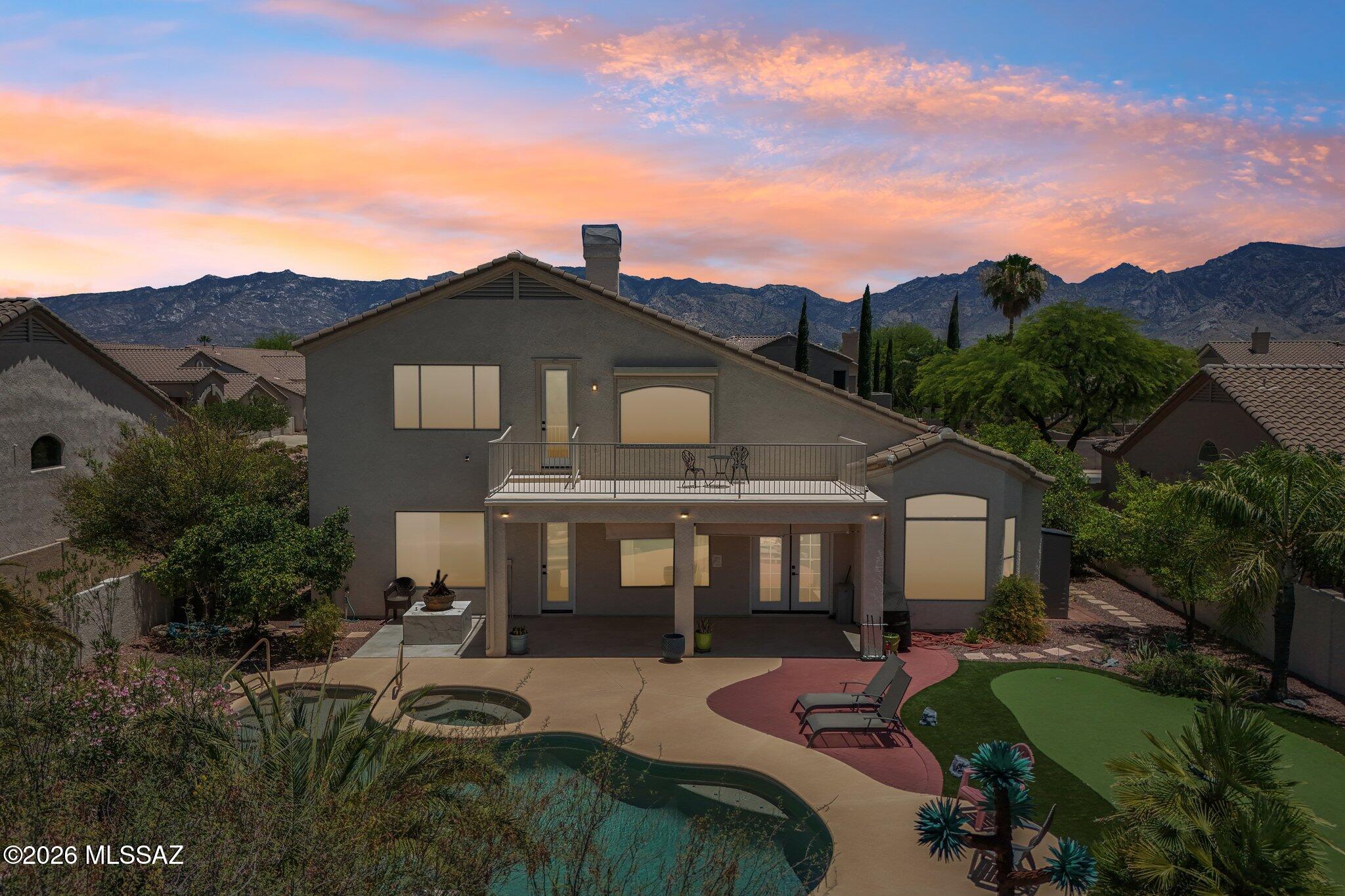 Beautifully remodeled 5BD/3BA home with soaring vaulted ceilings, ceramic tile flooring throughout, and a 3-car garage. The flexible 5th bedroom serves as an ideal bonus room, office, gym, media room, or guest space. Enjoy resort-style outdoor living with a sparkling pool, spa, putting green, outdoor shower, and breathtaking Catalina Mountain views. Situated in a quiet neighborhood with no rear neighbors, this home offers privacy and unforgettable sunsets. Smart home features include Rachio irrigation, Pentair auto pool filler, landscape lighting, Eufy cameras, and ADT security. A proven Airbnb performer since 2023. Furnishings available separately through a bill of sale and are negotiable. Move-in ready and impeccably maintained!