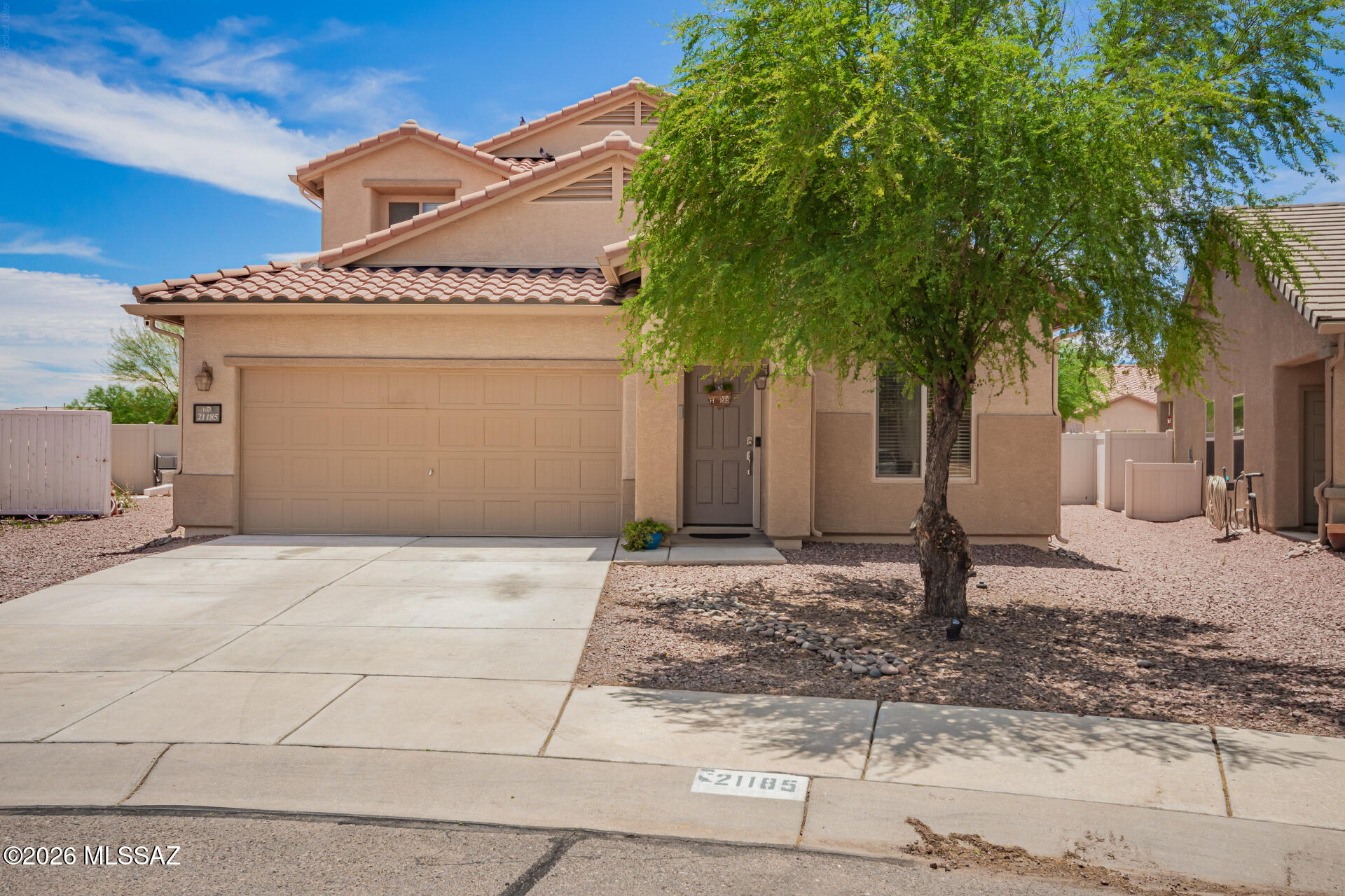 Welcome to your next chapter in vibrant Red Rock Village! This beautiful residence features owned Tesla Solar panels with new power inverter.  A spacious two-car garage and easy-care landscaping with Bluetooth irrigation system!  Step inside to discover an inviting open-concept living/dining space, seamlessly connected to the backyard. The kitchen boasts granite countertops, white cabinetry, stainless steel appliances, and recessed lighting. The primary suite is located on the main level and has a private bath with dual vanities and a walk-in closet. The versatile den is ideal for an office, while the upstairs loft offers the perfect space for a family room. The expansive backyard offers a covered patio, a built-in BBQ under the functional pergola, and abundant space for entertaining.