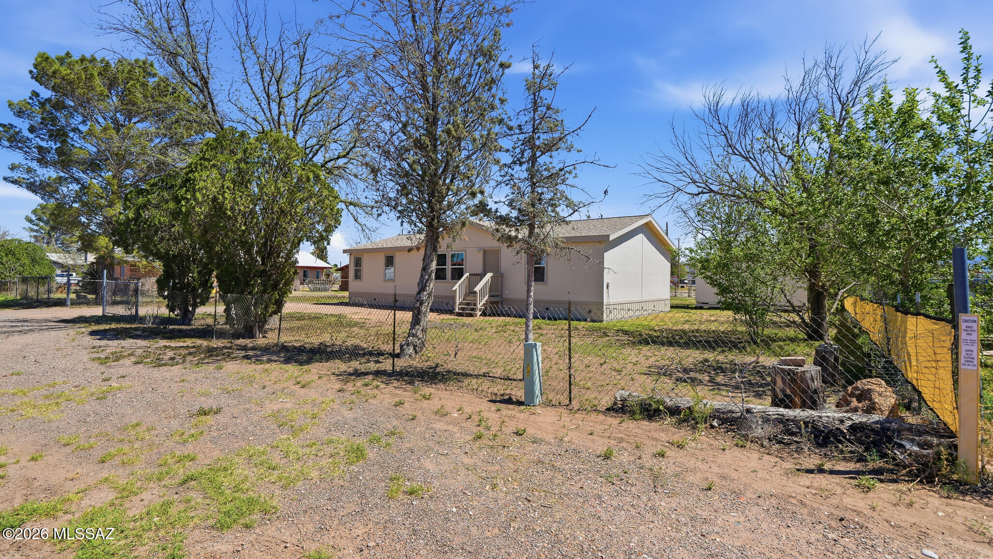STUNNING RENOVATION!!! GREAT PRICE! Possibly ZERO DOWN with USDA financing! Almost as good as new! Home sits on approx 1/3 acre fully fenced with rear alley access. Roof replaced about a year ago. New entry steps and skirting. Entire home painted inside and out. Beautiful, updated kitchen includes spacious cabinets, Lazy Susan, slide-out pantry shelves, granite countertops. ALL appliances - including washer/dryer AND big-screen TV are INCLUDED! Bathrooms updated with new tub and corner shower, new vanities with double sinks in primary bthrm. New flooring thruout. Let's not forget 4 new windows and all new window coverings! Lots of outdoor storage. Enjoy the shade trees AND large pecan tree. Access to home is on a paved road! Home is on City water and does have gas!