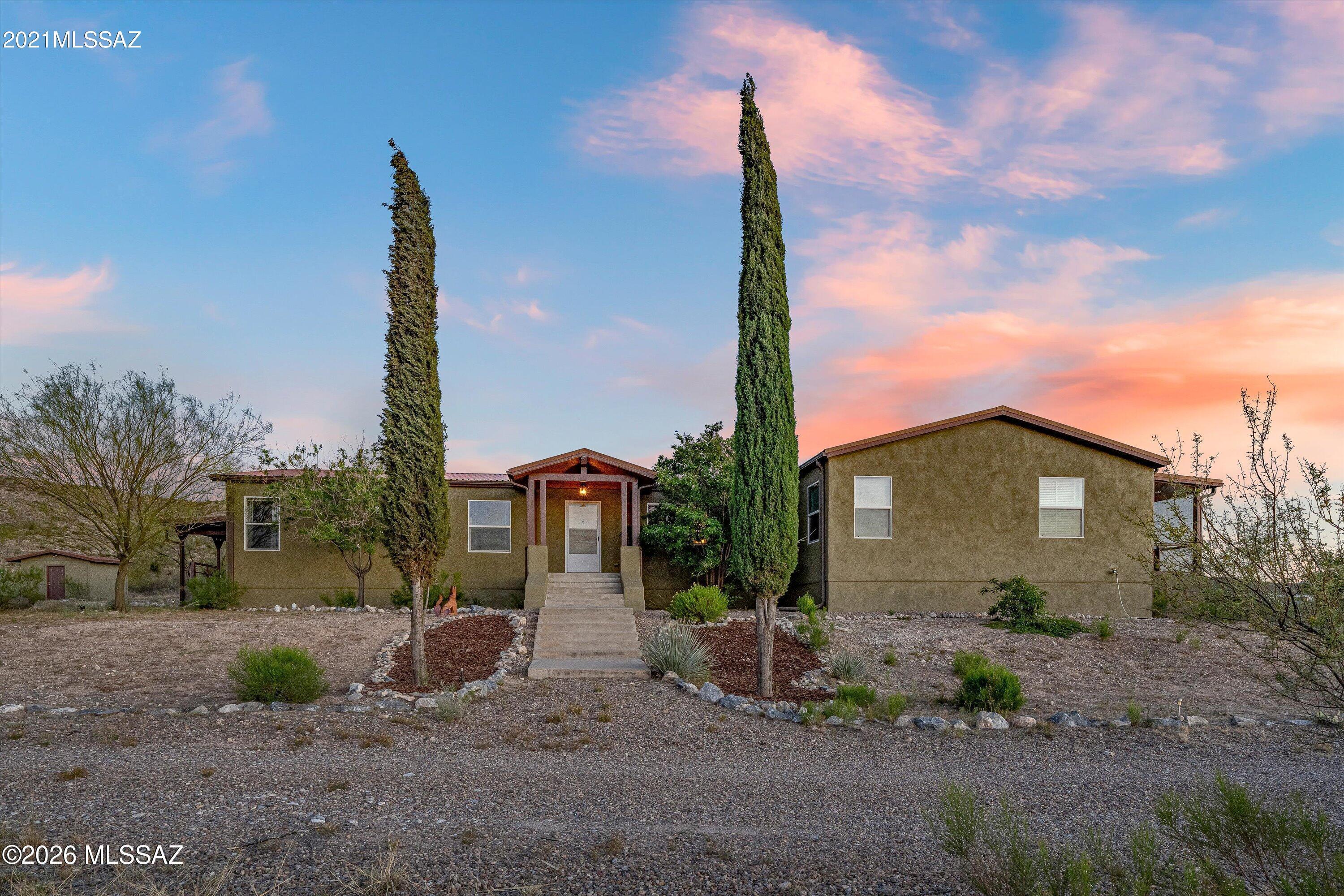 Beautiful, spacious 4 bedroom, 2.5 bath home with views to die for! Have you ever dreamed of having a vineyard as a neighbor? You will immediately be struck by the quiet, privacy and views that this home offers. And if you are a star gazer, this is the perfect spot. Still only 15 minutes to shopping at nearby Rita Ranch and 35 minutes to Downtown Tucson. The dirt road keeps out looky-loos but the average small car has no problem getting you home. Rural living at its best!