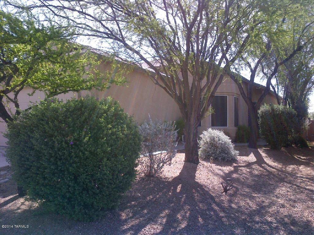 Owner/agent. Vail School District. 2-bedroom, 2-bath home offering 1,152 square feet of comfortable living space, built in 1996. This home features a private, walled backyard with mature oleander landscaping and an east-facing covered patio perfect for afternoon shade. Additional features include vaulted ceilings, 2-car garage, central air conditioning, ceiling fans, and solar screens to help keep utility costs low. 16-inch tile flooring runs throughout the home. The spacious primary suite includes a large bathroom with dual sinks, generous counter space, a garden tub/shower combination, and a walk-in closet. Please do not disturb occupant. Showings by appointment only. Managed by local owner/agent.