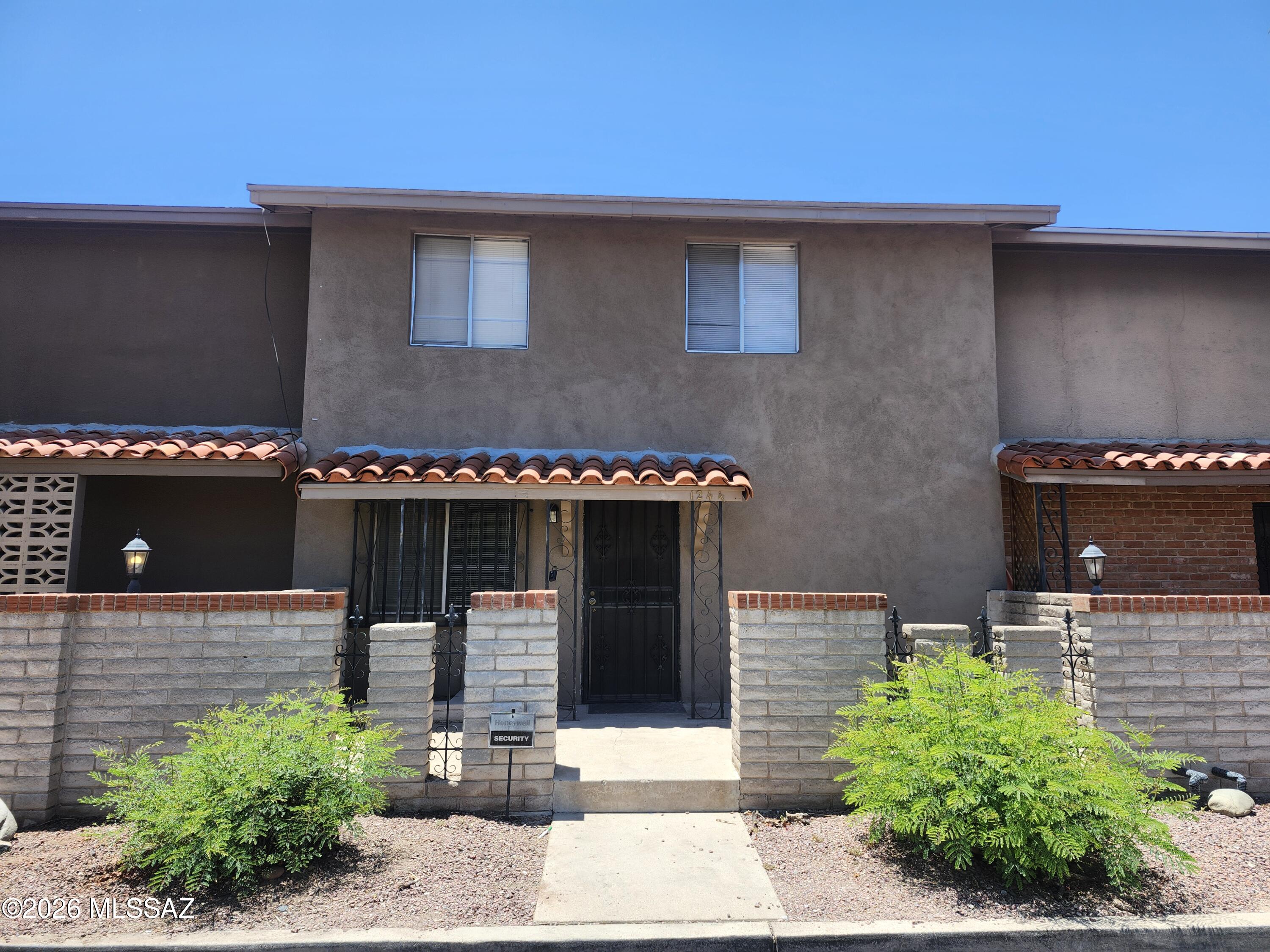 Discover this unique & spacious 3-bed, 3-bath townhome in East Tucson featuring a distinctive multi-level floor plan. The main level offers an open great room concept w/ dining area, a kitchen complete w/breakfast bar, & access to a covered patio w/storage room & washer & dryer. The lower level features a generously sized bedroom w/private full bathroom, ideal for guests, roommates, or additional privacy. Upstairs, you'll find two large bedrooms & another full bathroom. One of the bedrooms includes an attached office, study, or bonus room, providing flexible living space. With neutral tones, this home is move-in ready. Residents enjoy access to two community pools, two covered parking spaces, and the convenience of water, sewer, and trash services included in the rent.