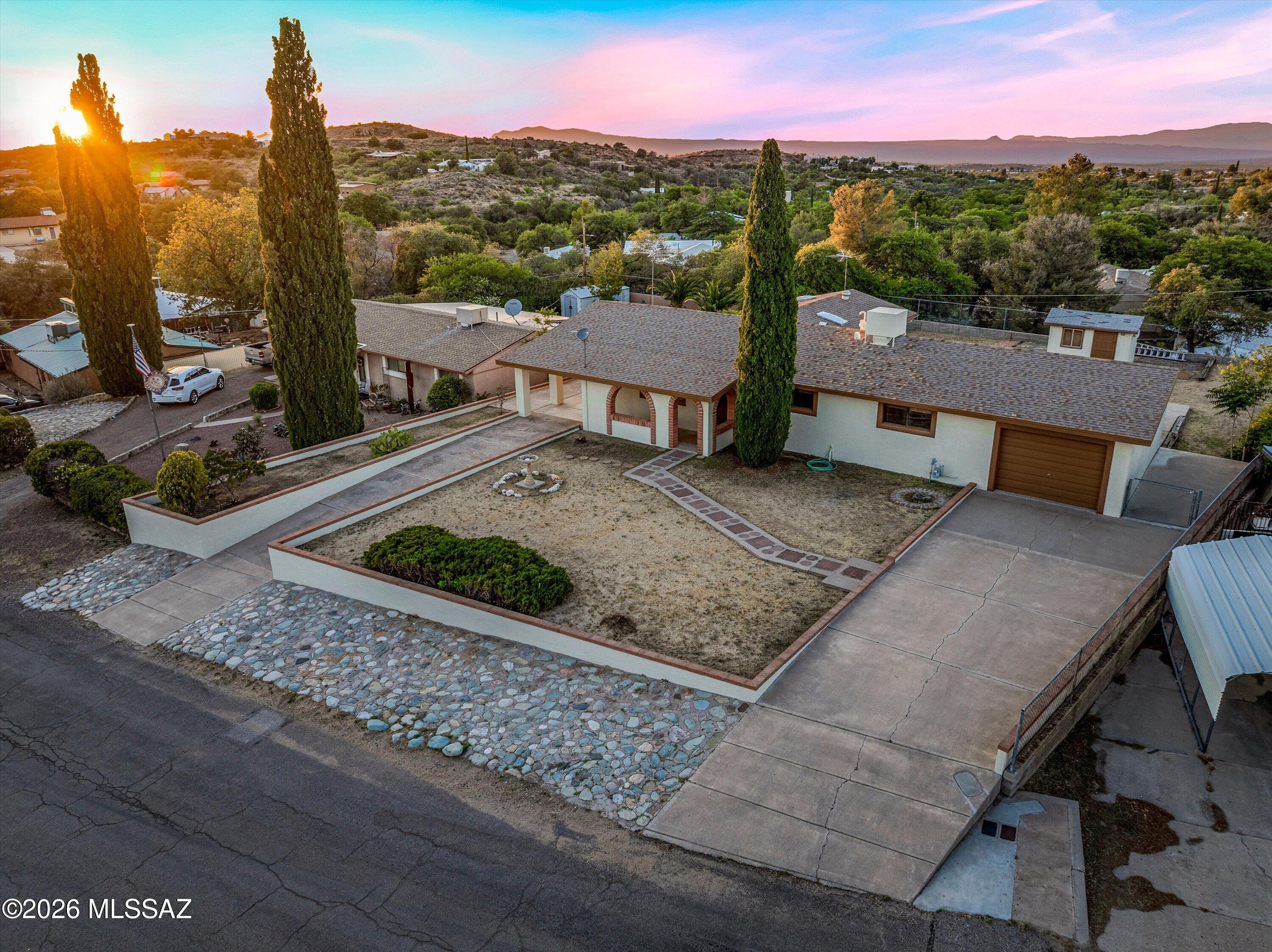 Charming 3-bed 2-bath block home, located in the heart of Oracle - this one-owner property has been well loved and well maintained!  The front yard has two large driveways with ample room for parking, and an extended one-car garage. The elevated lot provides extra privacy, along with views of the surrounding mountain ranges. The fully-fenced backyard features an additional workshop/shed with power, and multiple seating areas. The hallway bathroom has been completely updated, and the large family room addition with gas fireplace is the perfect place to relax. No HOA. Schedule a showing today and envision the possibilities!