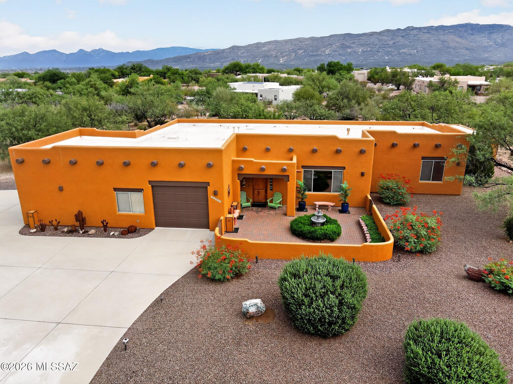Beautiful original owner Santa Fe style home in highly desirable Antler Crest Estates on just under an acre in award winning Vail school district w/oversized 3 car garage & separate 23'x12' workshop w/electric, & skylights.Large staggered tile throughout except BR's.Kitchen is a cooks delight w/granite countertops.upgraded cabinetry,skylight & large walk in pantry. Large family room w/fireplace for those cool winter nights.Front courtyard w/fountain is a great hang out spot.For a larger group the back north facing patio is fantastic w/66' long covered patio area w/fans & lots of beautiful tile, built in BBQ, & oversized ramada providing lots shade. BR's are good size,Primary BR has patio access & jacuzzi tub w/separate shower.Newer HVAC(2016), water heater(2025).Exterior Painted(2026).