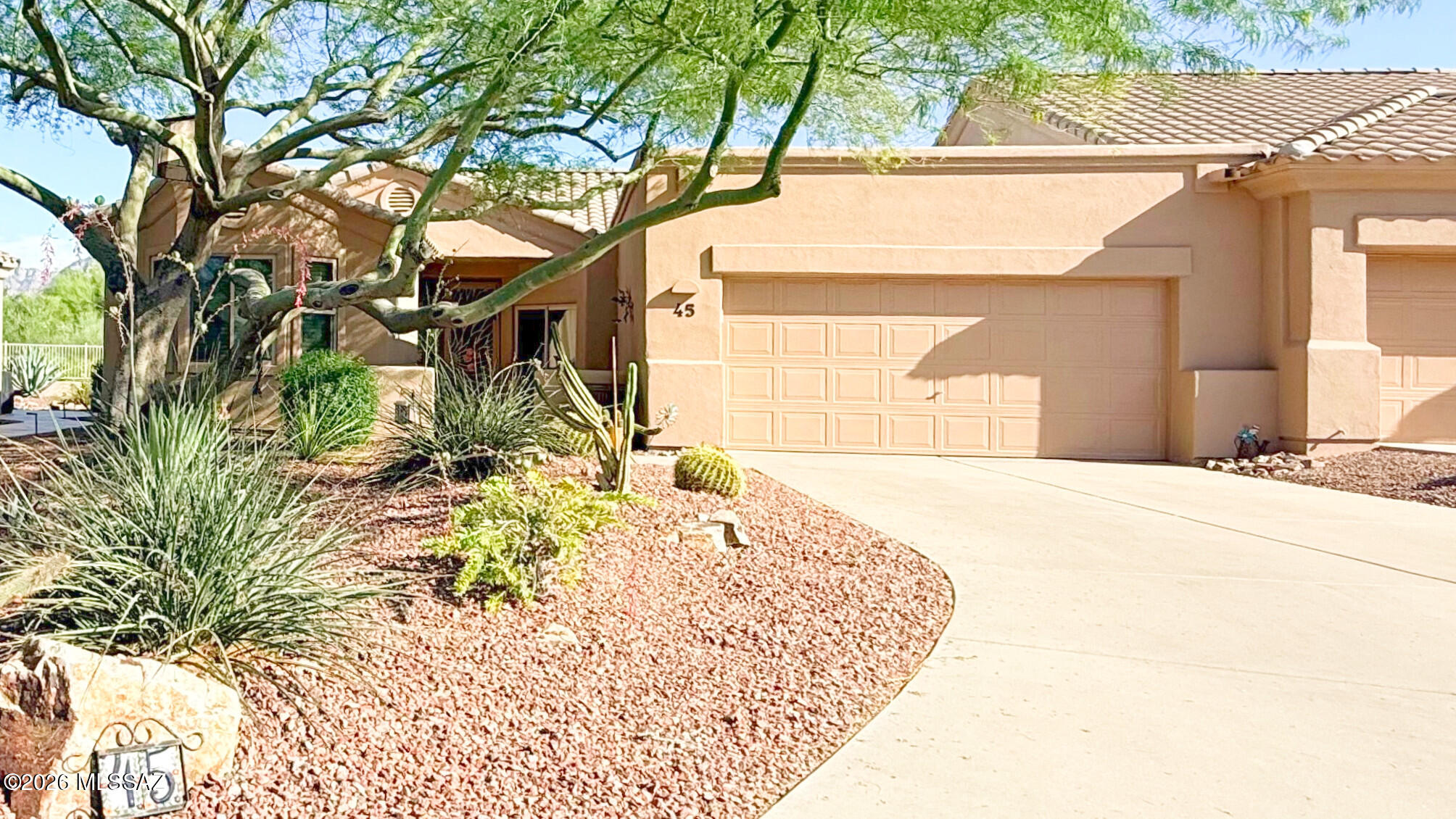 Perched on one of the most desirable lots in Vistoso Village, this meticulously maintained one-owner patio home captures stunning mountain views and backs to a peaceful park setting within the sought-after gated 55+ community.Offering 1,851 square feet of thoughtfully designed living space, this exceptional residence welcomes you with a charming front courtyard and an expansive great room highlighted by soaring ceilings. Elegant details, including a formal dining room, create a sophisticated yet inviting atmosphere. Abundant natural light pours through new energy-efficient windows and a sliding glass door, enhancing the home's bright and airy feel. The well-appointed kitchen is perfect for both everyday living and entertaining, featuring granite countertops, upgraded cabinetry with roll- outs, a stainless steel appliance package, a gas range, a breakfast nook, and a formal dining area. Beautiful tile flooring extends throughout the main living areas, while bay windows add character and charm to the bedrooms. The flexible floor plan includes two spacious bedrooms, two bathrooms, and a versatile bonus room complete with a built-in Murphy bed and custom office workspace--perfect for guests, hobbies, or working from home. Outdoor living is equally impressive. Professionally landscaped front and rear yards frame a private backyard retreat featuring an extended custom patio, gas hookup and breathtaking mountain views. Whether hosting friends or enjoying a quiet evening under the Arizona sky, this home is designed to be enjoyed both indoors and out. The two-car garage offers abundant storage cabinetry, a utility sink, a dedicated workbench, and an extra-long driveway that easily accommodates guests. Adding even greater value, the HOA provides a truly low-maintenance lifestyle by covering water and sewer service, trash and recycling collection, cable TV, in-home WiFi, front and backyard landscaping, exterior painting, monthly pest and termite control, roof and structure insurance, gated security, and full access to the community clubhouse and its extensive array of resort-style amenities. Rarely does a home combine premium views, exceptional privacy, extensive upgrades, and effortless living so seamlessly. This is Vistoso Village at its finest.