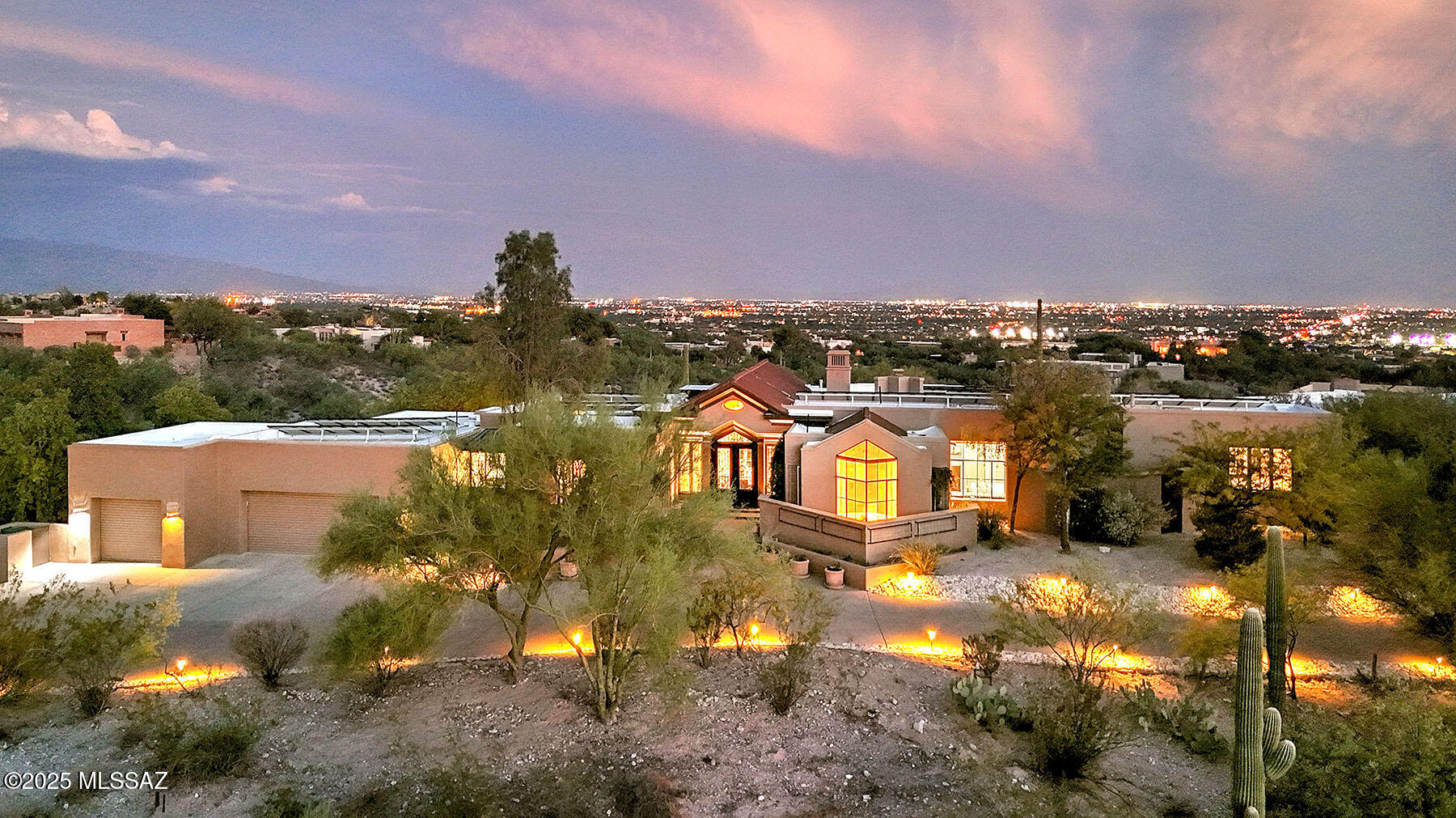 This Stunning soft contemporary sits high on a 1.6 acre ridge top overlooking panoramic city & mountain views in prestigious gated Catalina Foothills Estates #10. Custom wrought iron entry doors invites you into this beautifully remodeled home with 3978 sq.ft in the main house & a 331 sq. ft. guest house. A dramatic living room & dining room with high vaulted ceilings welcomes you with large picture windows to capture the views, elegant fireplace, beautiful wood floors, exquisite new gourmet island kitchen with custom cabinets, stainless steel Jenn-air appliances, double ovens, 36''induction cook top, 2 dishwashers, wine cooler, microwave drawer, refrigerator, prep sink, pantry, lovely breakfast area, spacious family room with built-ins, 4 bedrooms (split plan) & ....... continued....... 4 bathrooms in the main house including primary bedroom with fireplace, sitting area, travertine floors, luxurious remodeled bath with quartz countertops, dual sinks, separate shower, oversized tub & 2 walk-in closets. Amazing solar provides very low electric bills! The wonderful guest house features a bedroom & bath overlooking the fabulous backyard with covered patio, fenced pool, turf, play area, BBQ, lush vegetation, serene privacy, incredible views, oversized 3 car garage with storage area, Dist.16 schools & views, views, views !!

*See paid solar receipts under documents*