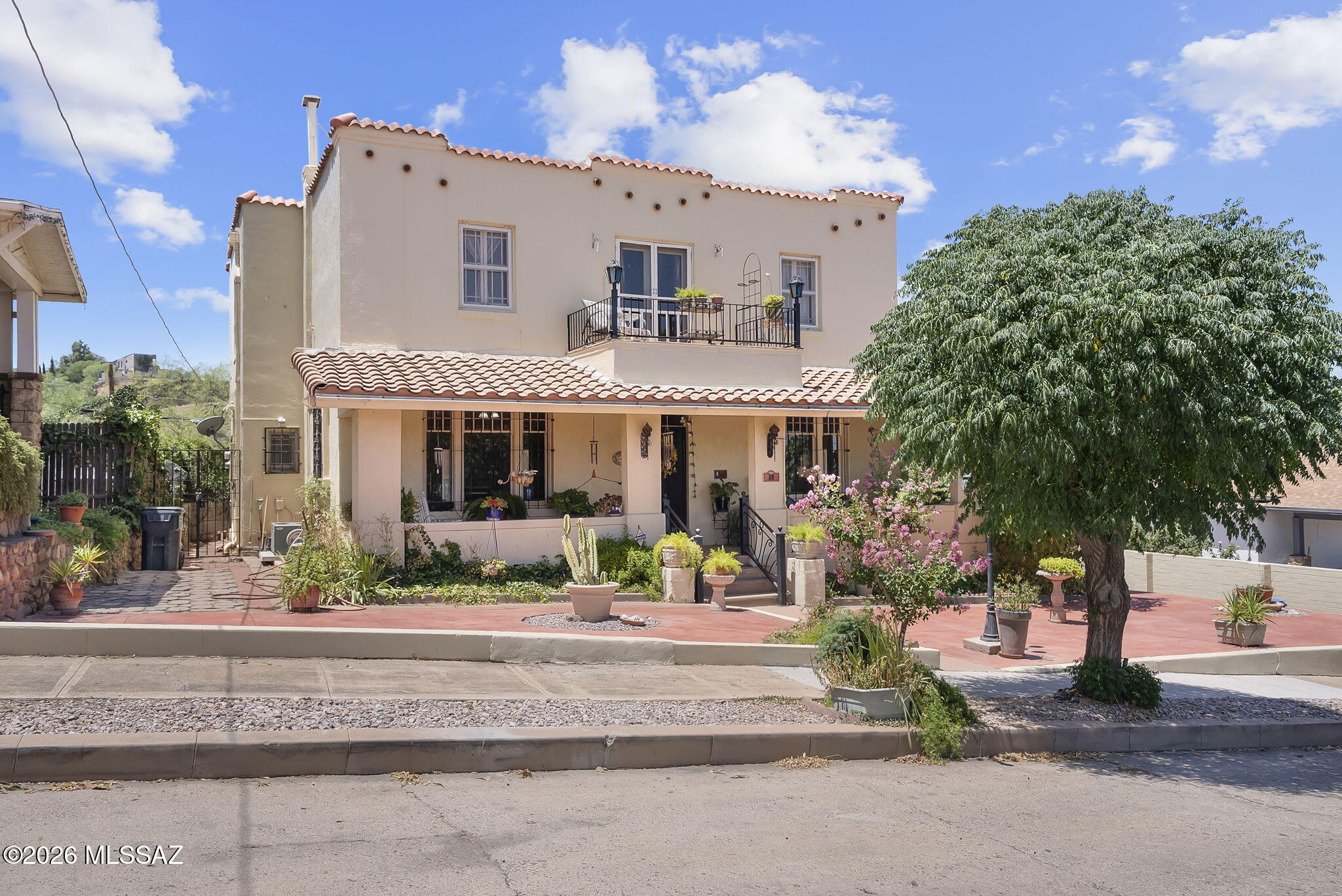 Step into a piece of Nogales history with this beautifully preserved historic home, ideally located in the heart of downtown. This charming residence offers 3 spacious bedrooms, 2.5 bathrooms, a two-car garage, and a detached 616-square-foot one-bedroom apartment--perfect for guests, extended family, rental income, or a home office.
Rich in character and thoughtfully updated, this home features soaring ceilings, a wraparound porch, hardwood, laminate, and ceramic tile flooring. Recent upgrades include a new heat pump, updated plumbing fixtures, ceiling fans in every bedroom, and select upgraded windows, providing modern comfort while preserving the home's timeless appeal.
The kitchen offers ceramic tile countertops, upgraded fixtures, a convection oven, and SS appliances, MORE making it both functional and inviting.  All bedrooms, bathrooms, and closets are exceptionally spacious. The upstairs bedroom opens onto a private balcony, while the primary suite features a large walk-in closet. A full basement provides ample storage space and includes a convenient laundry area.
Step outside to a beautifully landscaped courtyard with mature trees, creating a peaceful retreat that leads to the detached one-bedroom apartment. Whether you're looking for a primary residence, an investment opportunity, or a unique historic property, this move-in-ready home offers endless possibilities.
Located within Nogales' historic district, this exceptional property combines classic architectural charm with modern updates in one of the city's most desirable downtown locations. A rare opportunity to own a truly special home with history and character.