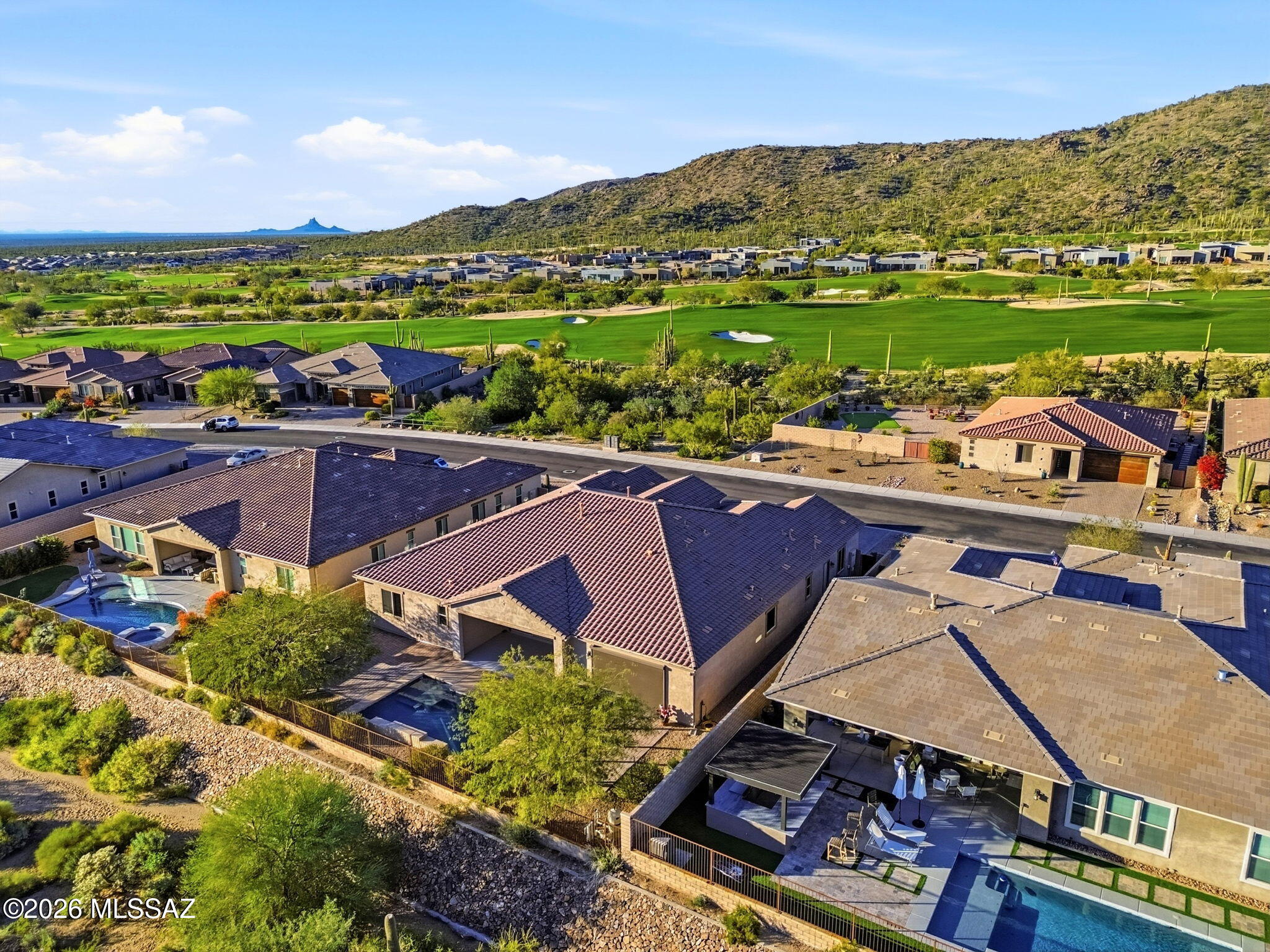 Almost brand new, located in gated community - Dove Mountain. Main house is 4 bed,4bth + built-in library & 1 bed, 1 bth attached guest house w/kitchenette.  Overextended 3 car gar & roman style pebble tech swimming pl backs up to spacious green area w mtn views. Walking distance from golf courses and Ritz Carlton Hotel.  Just minutes from restaurants & shopping.  Enjoy the high ceilings, custom finishes throughout, large picturesque windows/sliding doors & natural light. Split bedrm floorplan, 4 zoned hvac, HERS Index insulation, butler's pantry, keydrop area, sink in laundry, 2 large walk-in closets in master.Access to laundry rm from master bed.Kitchen inc granite, stainless steal, pull out shelves, soft close, pot filler, under counter lights. Alarm system & new wrought iron front door Richmond American Robert floorplan. 
Other features and benefits:
Eat in kitchen and breakfast bar
Great room floor plan
Surround Sound
Ceramic floors and luxury vinyl though out.  New carpet in some bedrooms. 
12 foot ceilings in great room
Television in living room stays
Quartz counters at kitchen island
Granite in the rest of the kitchen and baths
Separate formal dining
Library/office space with built-in and hidden safe stays
Plantation shutters
New paint throughout
All 5 bedrooms have access to their own bathroom.  Only bed 3 and 4 share a Jack and Jill bath.  
Master bedroom has two extra size walk in closets with built-in storage.  Master bedroom comes with a full shade screen and remote.
Guest house is perfect for mother-in law quarters or guests.
Join the Social Fitness Gallery which includes, pools, restaurants, spa, gym, picklebal, tennis, park ect.  Play golf nearby at public or private courses.  Not an age restricted neighborhood.  
Electric hook-up for electric vehicle available in garage    
Large trucks can fit in the garage. 
Water softner is upgraded. 
Grab bars in showers .
2 tubs and 5 showers in the home.
Gas stub installed in back and grill stays. 
Pool just serviced. It was acid washed, sandblasted, and new filter installed.  Pool is self cleaning and self leveling.  Includes a fountain.  
 
Some furniture negotiable for sale .