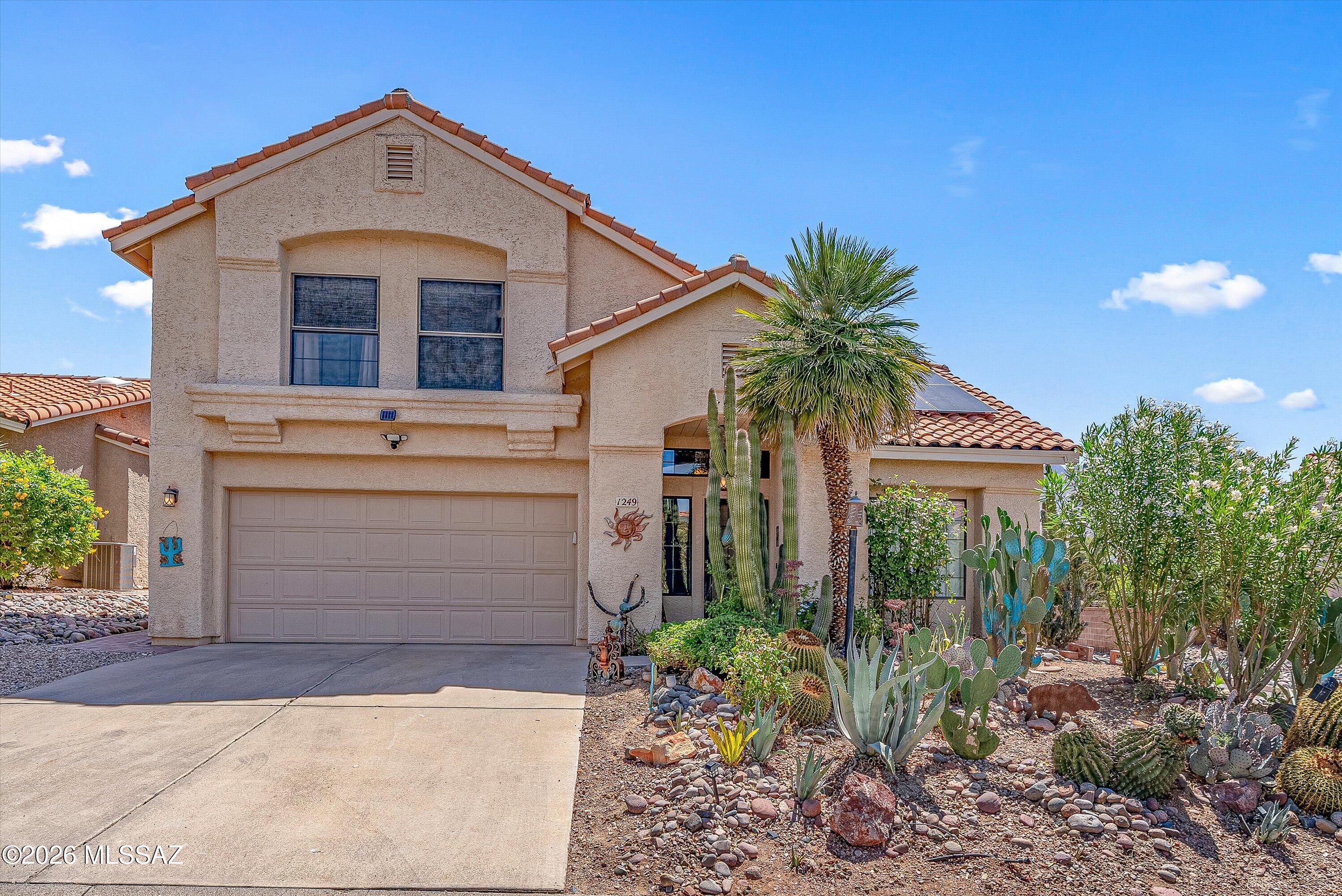 Desirable golf course lot located in a gated community, all in the heart of Oro Valley.  Beautiful mountain views, gourmet kitchen, granite countertops, breakfast bar, custom cabinetry, bay window, den with a fireplace, slate tile throughout the ground floor, wood laminate throughout the second floor, huge master suite with a private balcony, large walk-in closet, soaking tub, separate shower, and granite countertops.  The private backyard is designed to entertain, with a covered patio, built-in grilling station, pebble-tec pool, above-ground spa, fully landscaped, and views of Pusch Ridge. The solar system is owned and saves thousands on electricity.  This was a very successful AIRBNB and could be sold turn-key. Solar paid in full. NO POLY PIPES.