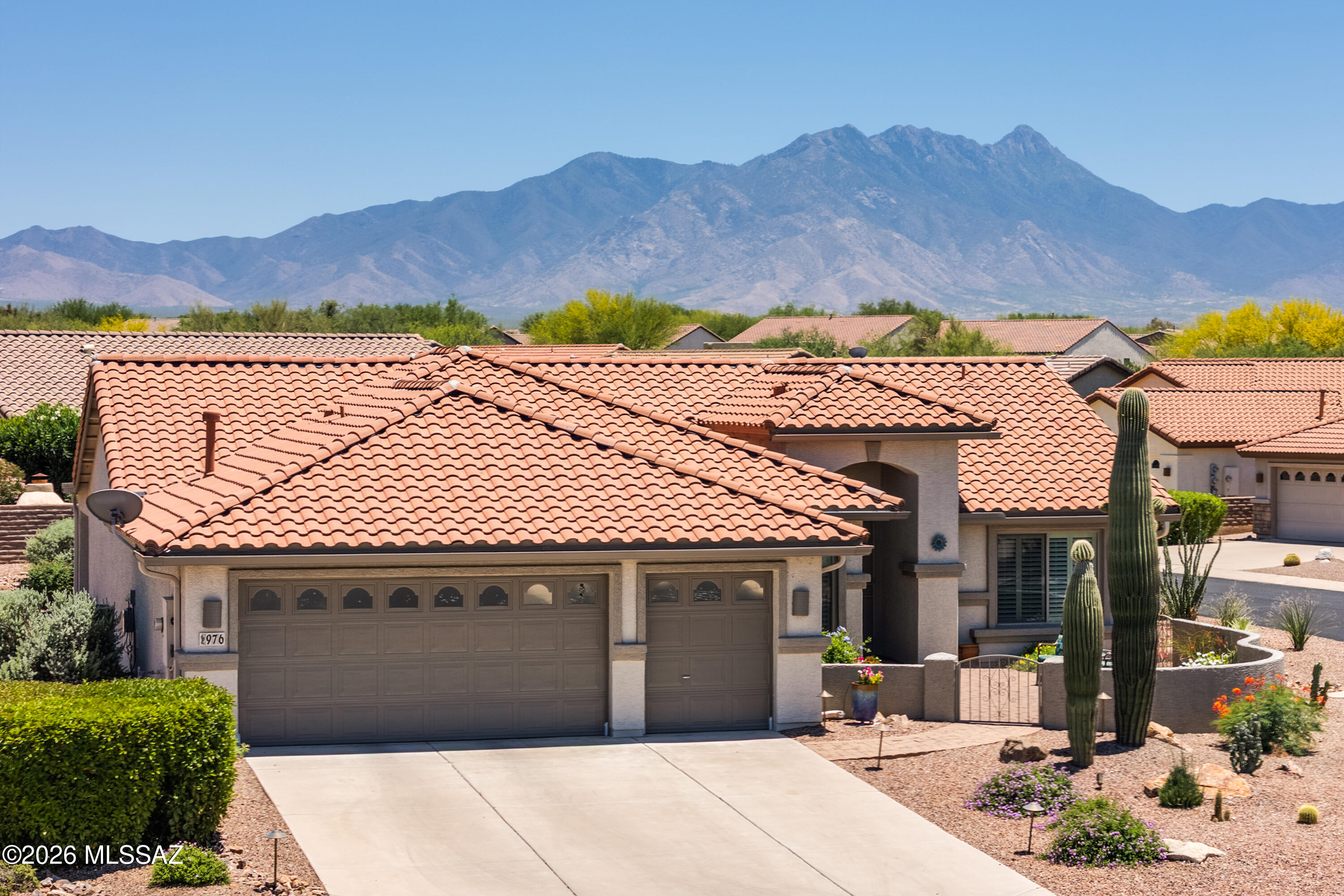 Situated on a prime corner cul-de-sac lot in Quail Creek, this expanded and updated Laredo model offers 1,960 sq. ft., 2 BR, 2 BA, a versatile den, golf cart garage, new roof and HVAC system, and a beautifully updated kitchen. Attractive front desert landscaping, highlighted by two majestic saguaros, creates outstanding curb appeal, while the gated front paver courtyard provides a welcoming entry and an ideal setting to enjoy sunset views. A wrought iron security door opens to the foyer and spacious great room, featuring a cozy gas fireplace, built-in display niches, and generous space for both everyday living and formal dining. The interior has been thoughtfully refreshed with newer paint, updated ceiling fans, and modern lighting, creating a warm and inviting atmosphere throughout. Plantation shutters throughout complement the home's refined finishes. The recently updated kitchen is both stylish and functional, showcasing granite countertops, tile backsplash, new stainless steel appliances including electric range with induction cooktop, composite sink, reverse osmosis, breakfast bar, center island, pull-out shelves, and a pantry closet with custom built-in organizers to maximize storage. An adjacent, 4' expanded dining nook offers the perfect setting for casual meals. The owner's suite features a bay window, dual vanity bath with a new toilet/bidet, beautifully tiled walk-in shower, and a spacious walk-in closet. The guest bath also includes a new toilet, and a two-foot extension to the guest bedroom, guest bath, and den enhances comfort and flexibility. The den provides an ideal space for a home office, reading room, or hobby area. A spacious laundry room includes a newer washer and dryer, adding convenience and functionality. 

Outdoor living is equally inviting with a covered rear patio featuring updated fans, and extended pavers. The backyard also includes updated landscaping, landscape lighting, and a new drip irrigation system (2023). Extensive recent upgrades provide peace of mind, including new exterior paint (2022), new HVAC (2023), new roof (2024), new water softener, new front gutters over the front entry, and a whole-house surge protector. This beautifully maintained and extensively upgraded home offers the exceptional Quail Creek lifestyle.