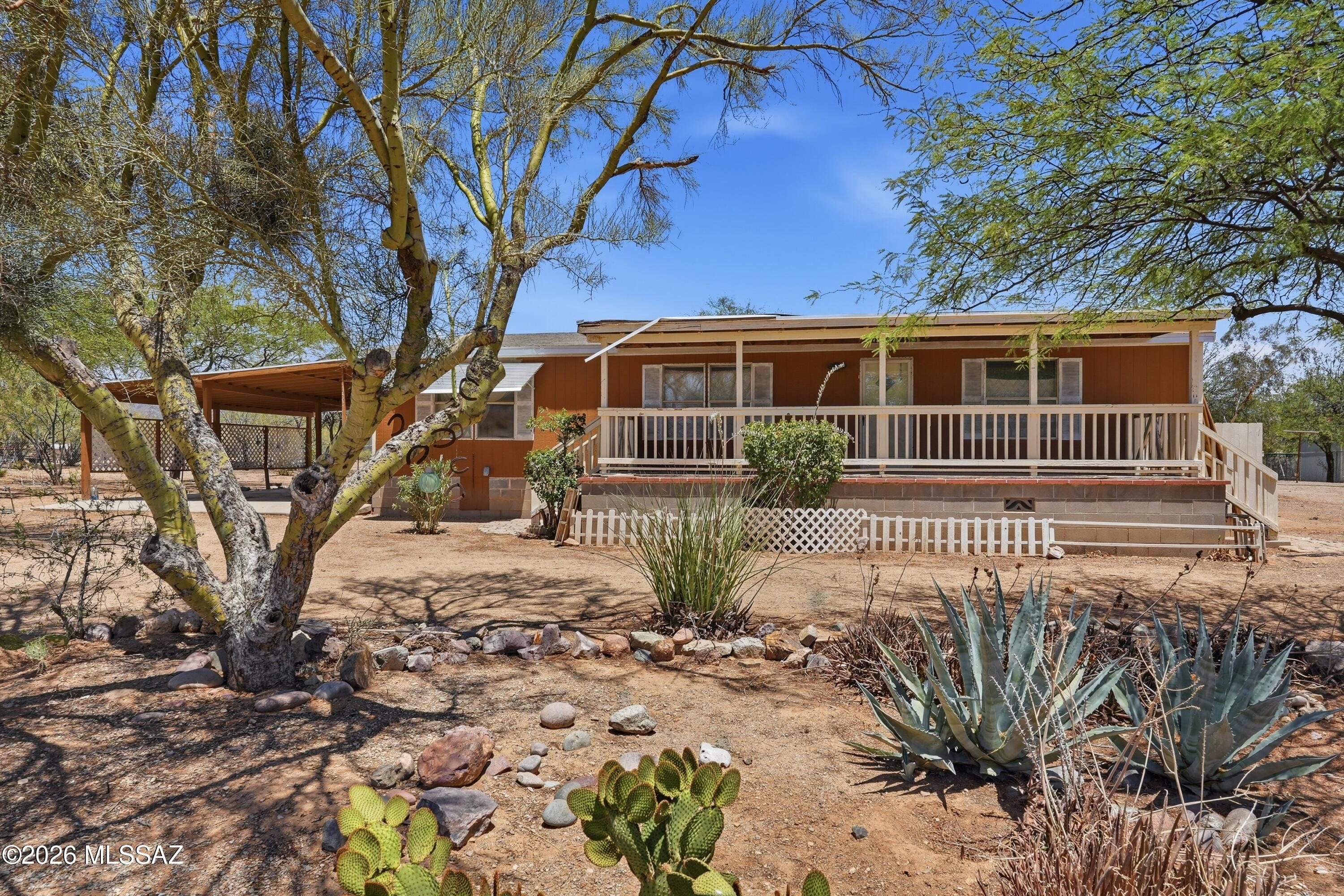 Enjoy the beauty and privacy of Tucson's west side with this charming home situated on a spacious lot surrounded by stunning Sonoran Desert scenery. Offering comfortable living spaces, a functional layout, and abundant natural light, this property is perfect for those seeking room to spread out and enjoy Arizona living. The expansive lot provides ample space for RV parking, recreational vehicles, hobbies, or future improvements. Relax on the covered porch while taking in breathtaking mountain views and spectacular sunsets. Conveniently located near Tucson Mountain Park, hiking trails, and outdoor recreation, yet just a short drive from shopping, dining, and everyday amenities. A rare opportunity to enjoy peaceful desert living with endless possibilities.