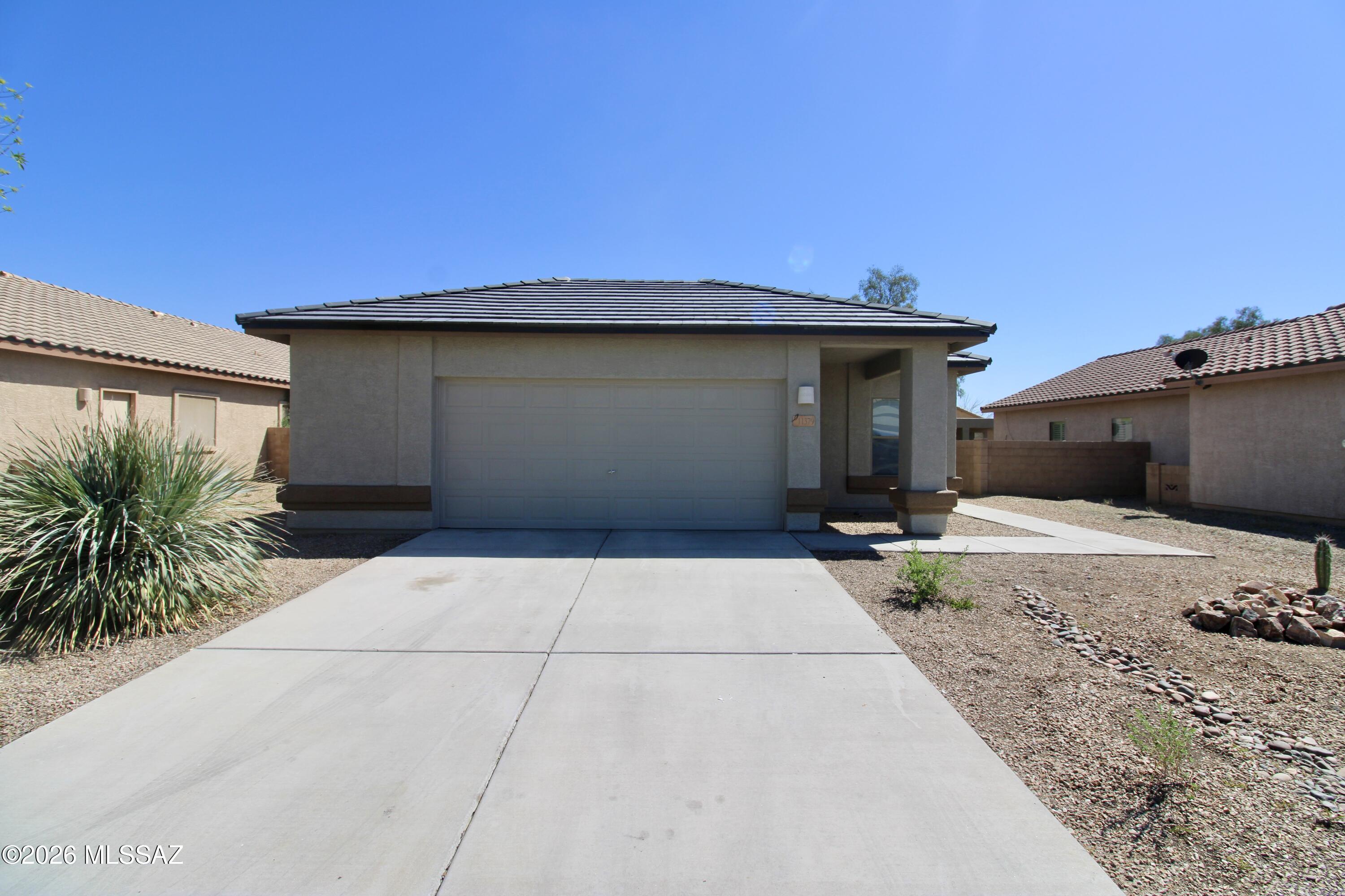 1,265 SQ FT! 3 bedroom, 2 bath home in Marana's Gladden Farms! Desirable single story floor plan with welcoming great room entry. Charming kitchen with new appliances, & ample cabinetry/countertop space! Neutral interior with fresh paint throughout + tile flooring in all the right places. This home offers 3 nicely sized bedrooms, each with ample closet space! Primary suite with full bath. Blinds + ceiling fans! Enjoy a low up keep backyard with covered patio. 2 car garage! Gladden Farms is a well maintained community with biking/walking trails throughout.