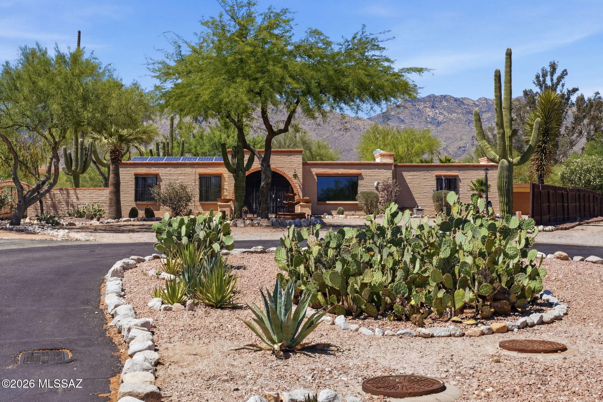 Nestled on a premium view lot in a scenic foothills cul-de-sac, this exceptional desert retreat offers the perfect blend of luxury, comfort, and functionality. Featuring an owned solar system, sparkling pool, relaxing hot tub, putting green, and a versatile heated/cooled exterior studio with mini split, this home is designed for both entertaining and everyday living.

Inside, timeless character shines through with dual fireplaces, custom built-ins, and expansive picture windows framing breathtaking mountain and city light views. The spacious family room offers warmth and charm, while the formal living and dining areas create an inviting atmosphere for gatherings. Step outside to your private resort-style backyard complete with mature desert landscaping, towering saguaros, tranquil fountain, outdoor ramadas, extended covered patio, and multiple spaces to relax or entertain under the Arizona sky.

Additional highlights include a newer AC system, 3-car garage, extra carport parking, and a flexible detached studio ideal for guests, hobbies, office space, or fitness.

An entertainer's dream in the coveted foothills, where spectacular views and desert elegance come together seamlessly.