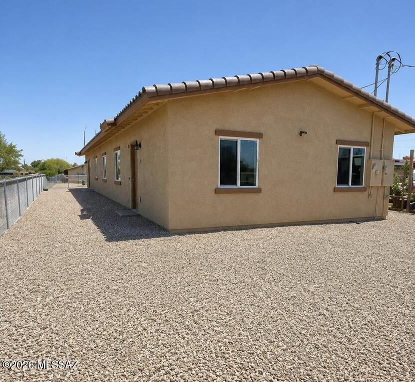Outstanding investment opportunity! This duplex features two thoughtfully designed units: one offering 3 bedrooms and 2 bathrooms, and the other with 2 bedrooms and 1 bathroom, making it ideal for investors or owner-occupants looking to live in one unit while generating rental income from the other. Conveniently located less than 3 miles from the University of Arizona, approximately 2 miles from Downtown Tucson, and with quick access to I-10, this property is close to shopping, dining, entertainment, and major employment centers. Each unit is separately metered for electric and water, providing added convenience and efficiency. Don't miss the opportunity to own this income-producing property in a highly desirable location!