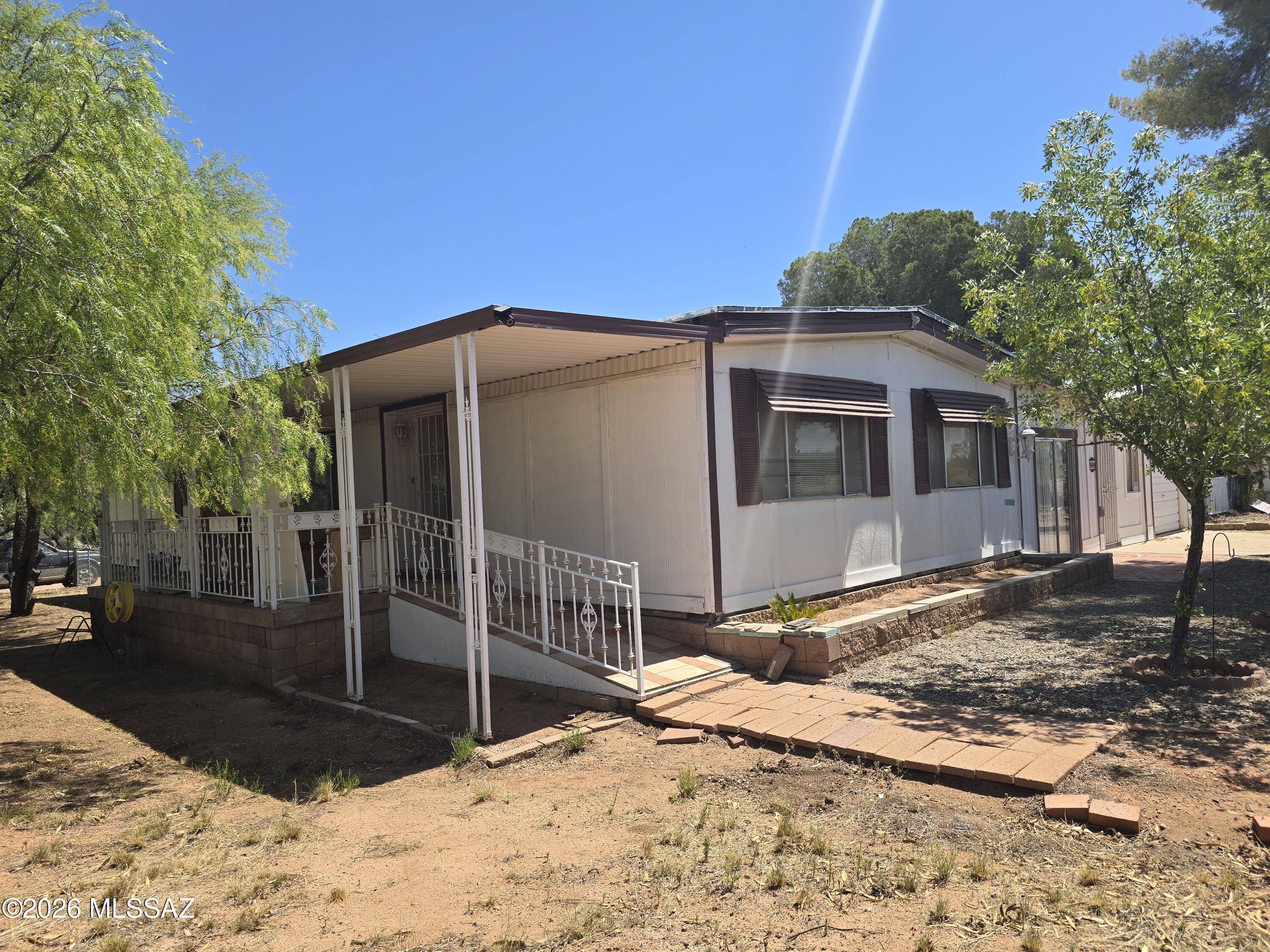 Well loved three bedroom, two bath has been upgraded with new electrical service and recoated roof, and many other updates.  Huge Arizona room, plus oversized garage/workshop that is heated and cooled.   Mature trees and easy care landscaping on chain link fenced corner lot.