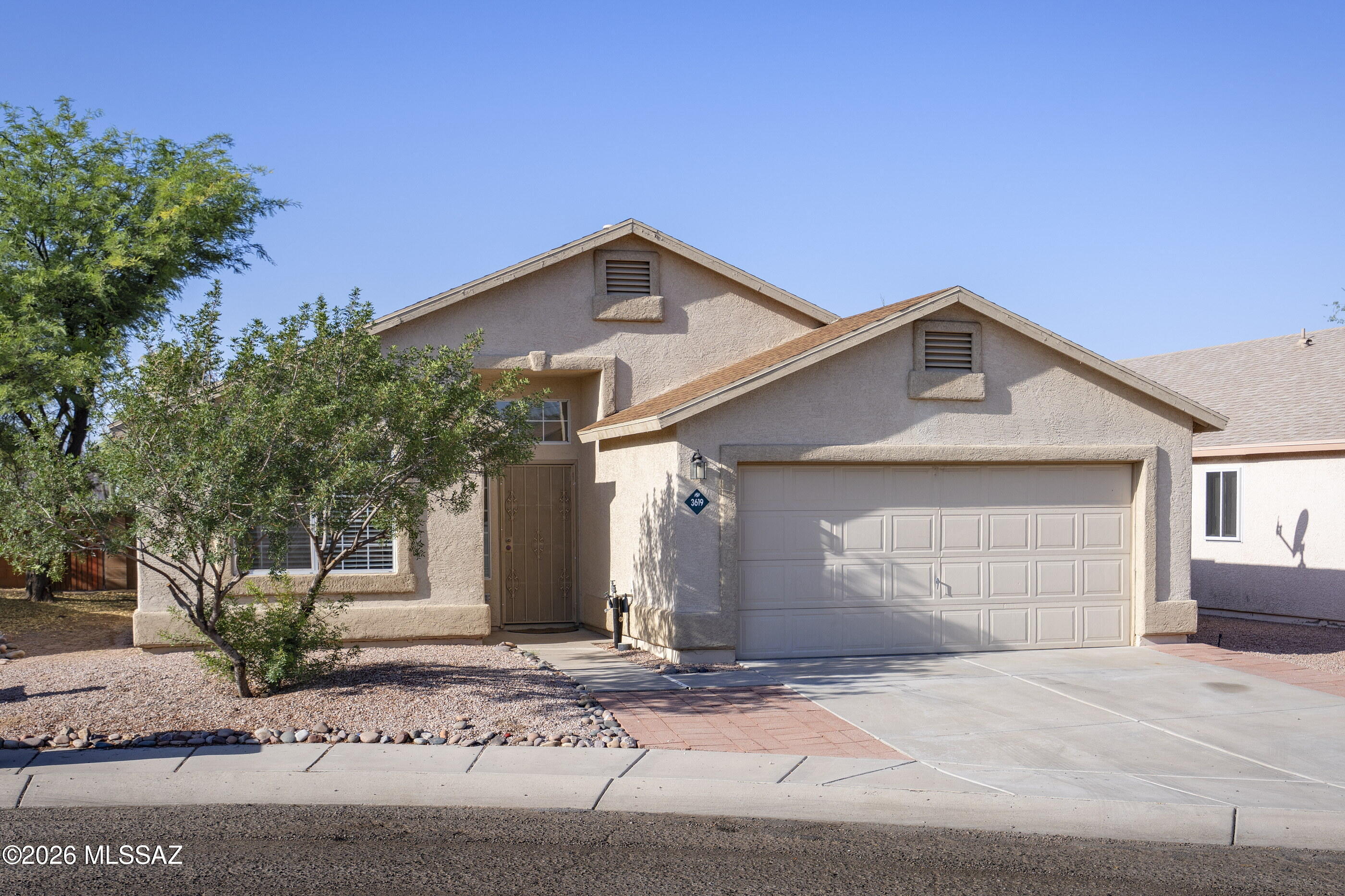 Located on a cul-de-sac, this three bedroom, two baths with N/S exposure is close to all conveniences! Your new home has vaulted ceilings, LVP wood flooring in the bedrooms and ceramic tile throughout the rest of the home. The layout features a desirable split-bedroom floorplan for privacy. With two large living spaces, this home offers flexible options for any lifestyle. The light-filled front living space has a tile ''rug'', a sloped ceiling and a fan with chandelier lighting. The great room is open to the kitchen and has French doors leading to the outdoor space. Fully outfitted with newer stainless steel and ''slate'' appliances (including a range with dual ovens), the kitchen has granite counters and a granite topped kitchen island with room for barstools. The private primary bedroom generously sized and has soaring ceilings with a fan.  In addition to having a full private bath with an oval soaker tub, separate shower and granite counters, the primary bedroom also features a walk-in closet and access to the covered patio. Both guest bedrooms have ceiling fans and are serviced by a full hall bath with granite counters. A laundry room off the hall leads to the two car garage. Outdoors, the backyard has a covered patio with a brick paver extension and faux grass. This space is ready for your plantings or other landscaping--and has an area bordered off by pavers that would make a great space for a little garden. Everything is close by-- under 5 minutes to the nearest grocery store and dining options --and just 10 minutes to Wal-Mart, Costco and two large shopping centers with theaters, shopping and services.