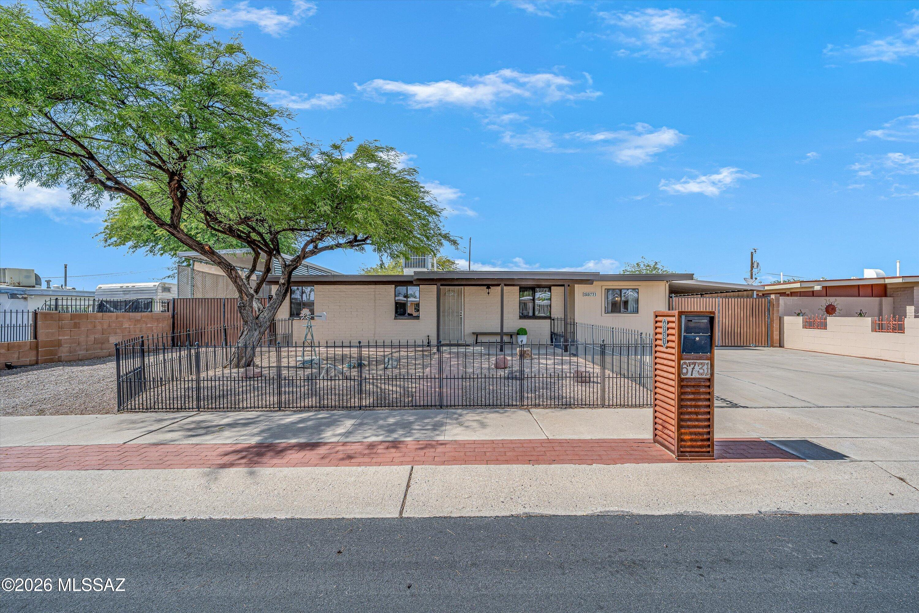 Charming & well-maintained, this 3-bedrm, 2-bath home offers plenty of space & versatility inside & out! The functional floor plan features both living & family rooms, along with a bright, eat-in kitchen & no carpet throughout. Two mini-splits provide additional comfort, while a 150 sq. ft. interior workshop off the laundry room offers extra space for hobbies, projects, or storage. Outside, you'll find a fully fenced front yard & a beautifully landscaped backyard with a covered patio & nice storage shed. An extended, gated RV carport with access to sewer & electric, tandem carport, also behind a sliding gate, & 1-car garage provide abundant parking & project options. With flexible living spaces & plenty of room for your vehicles, RV, hobbies, & more, this inviting home has so much to offer