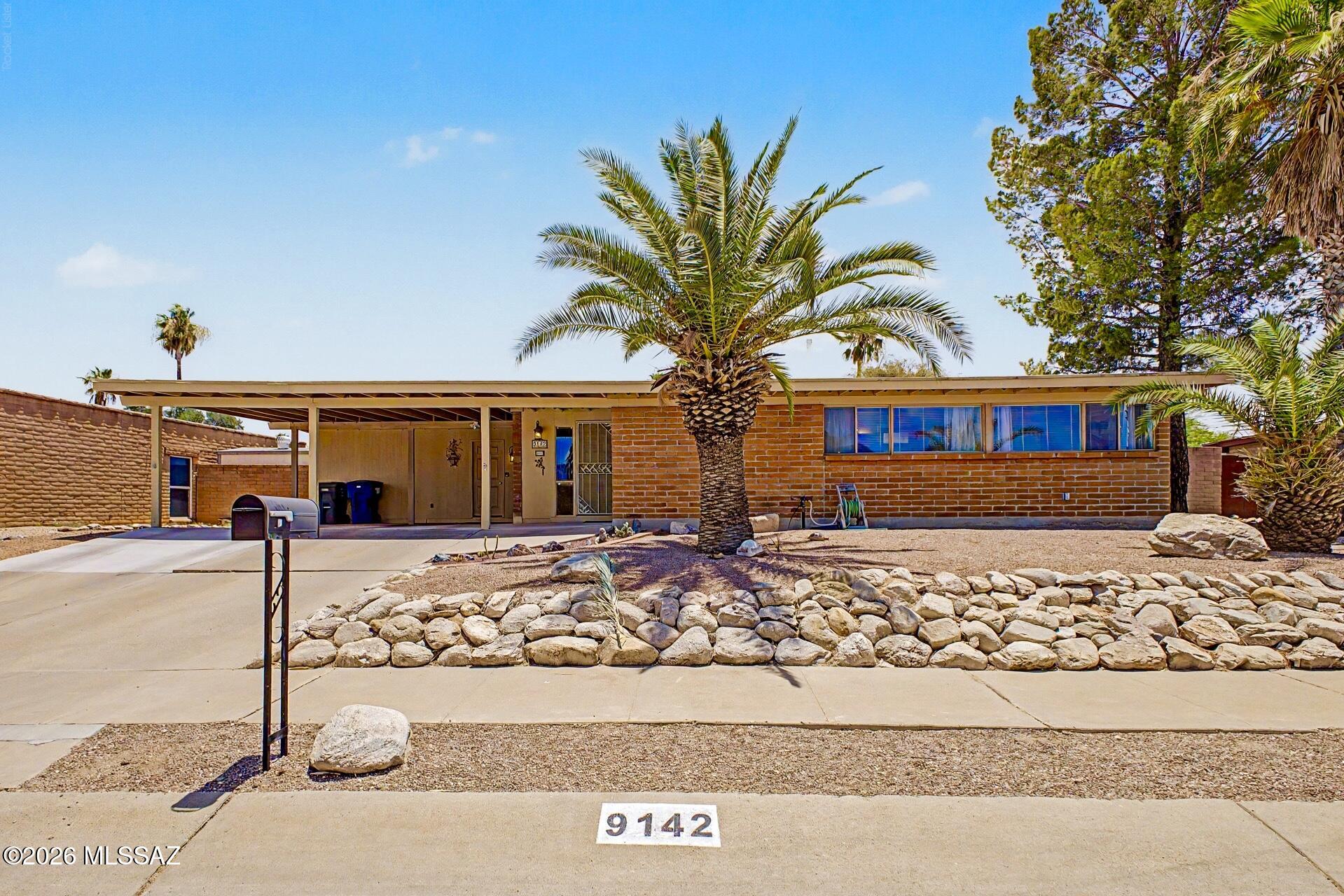 Seller to accept or counter between $335,000 - $345,000. Fully furnished 3-bedroom, 2-bath home with a proven history as a successful vacation rental. Towering palm trees and established landscaping create exceptional curb appeal, while the private walled backyard offers a true Arizona retreat. Enjoy a sparkling pool with new heater and pump, a refinished built-in spa, artificial turf, and inviting outdoor living spaces designed for relaxing and entertaining year-round. Full-grown pepper trees provide abundant shade, while citrus trees add to the charm and character of the backyard setting. Inside, bright living spaces, tile flooring, and abundant natural light create a comfortable atmosphere. Whether you're seeking a full-time residence, winter getaway, or turnkey investment property. Ideally located near Saguaro National Park and other outdoor recreation opportunities, it offers the best of the Tucson lifestyle.