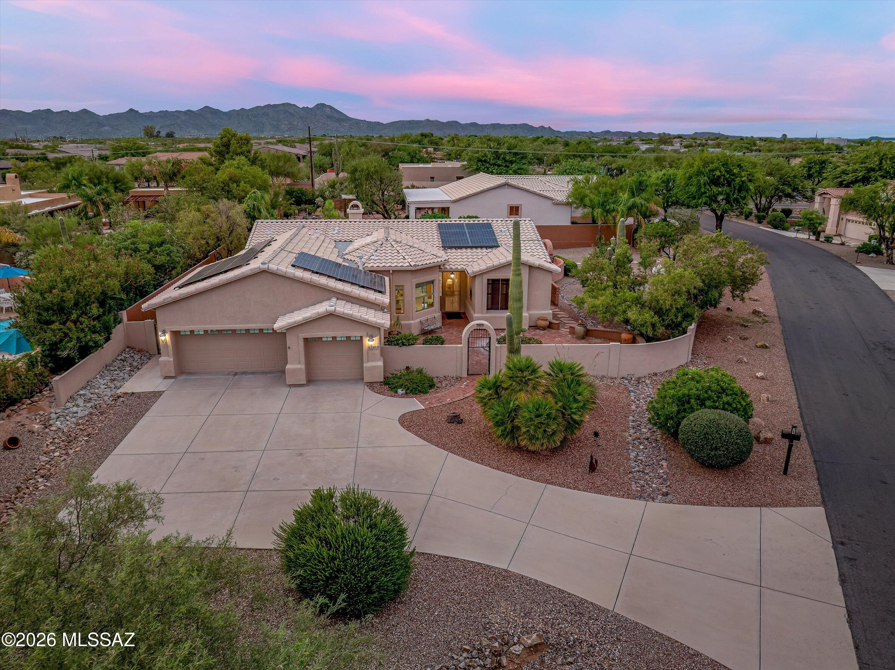 Nestled in desirable Naranja Ranch, this impeccably maintained 3-bedroom, 2-bath residence offers 2,026 square feet of thoughtfully designed living space on a beautifully landscaped nearly half-acre homesite. From the moment you arrive, you'll appreciate the pride of ownership, mature landscaping, and exceptional outdoor living spaces that make this property special.
Inside, soaring ceilings, fresh paint, and beautiful ceramic tile flooring throughout create a bright, open feel that lives larger than its square footage. The remodeled primary bath features an elegant walk-in shower, while the modern kitchen flows seamlessly into the dining area and spacious great room with gas fireplace.
Step outside to a large screened patio overlooking a sparkling heated pool with a retractable sunshade creating an inviting space for year-round entertaining and relaxing. Expansive front and back yards showcase lush landscaping, included decorative outdoor features and even some Pusch Ridge views to the East.
Additional highlights include a premium H2O Concepts whole-house water treatment system, a custom fitted pool cover, epoxy-coated garage floor, completed exterior painting, and meticulous maintenance throughout, making this home truly move-in ready.

To top it all off, enjoy remarkably low electric bills thanks to a fully paid Tesla solar lease with ten years remaining--a benefit enhancing both comfort and value.