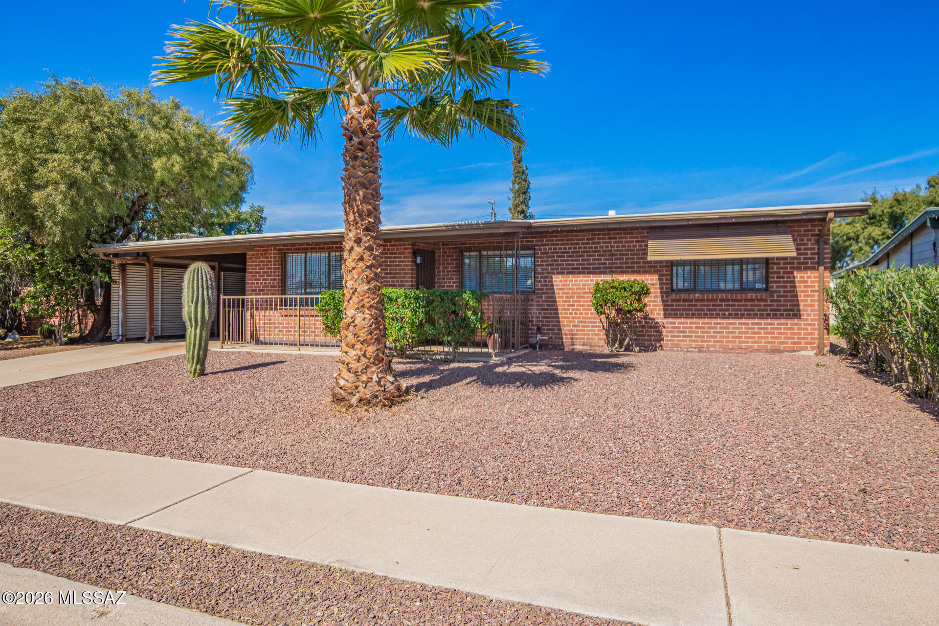 Beautiful single-story brick style home with 3 bedrooms, 2 baths and attached carport located in a wonderful neighborhood in  Tucson: NO HOA-Recoated ROOF, remodeled bathrooms lots of updates , Backyard basketball court ! Wood look flooring throughout, no carpet! Large family room, open kitchen featuring SS appliances, gas range, garden window, white crisp cabinetry, and modern counters.  Peaceful master includes private ensuite with stand in tile shower with pebble floor and vessel sink. Large backyard has covered patio and has plenty of space for a pool or future projects.