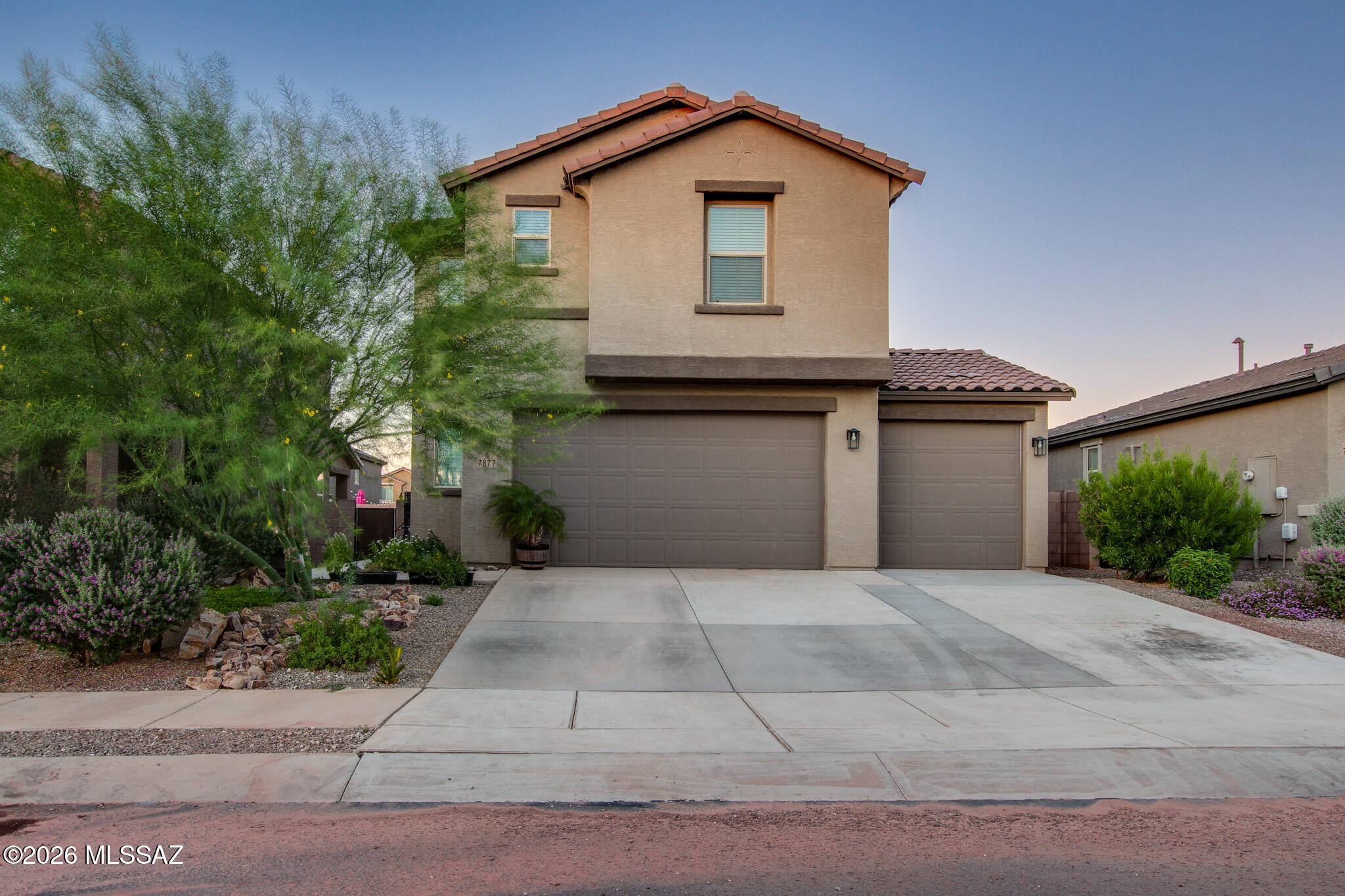 This beautifully maintained 2023 Richmond American two-story home offers 1,910 sq. ft., 4 bedrooms, and stylish finishes throughout. The open-concept design features gorgeous quartz countertops in the kitchen and all bathrooms, creating a bright, modern feel. Step outside to your private backyard retreat with artificial turf, low maintance landscape, a cozy outdoor fireplace, and a garden bed,  perfect for relaxing or entertaining. Located in the desirable Star Valley community, you'll enjoy nearby parks, walking paths, tennis courts, and plenty of open space for outdoor living. Move-in ready and meticulously cared for, this home combines modern comfort with an incredible lifestyle. Don't miss your opportunity to experience Arizona living at its finest. Schdule your showing today!