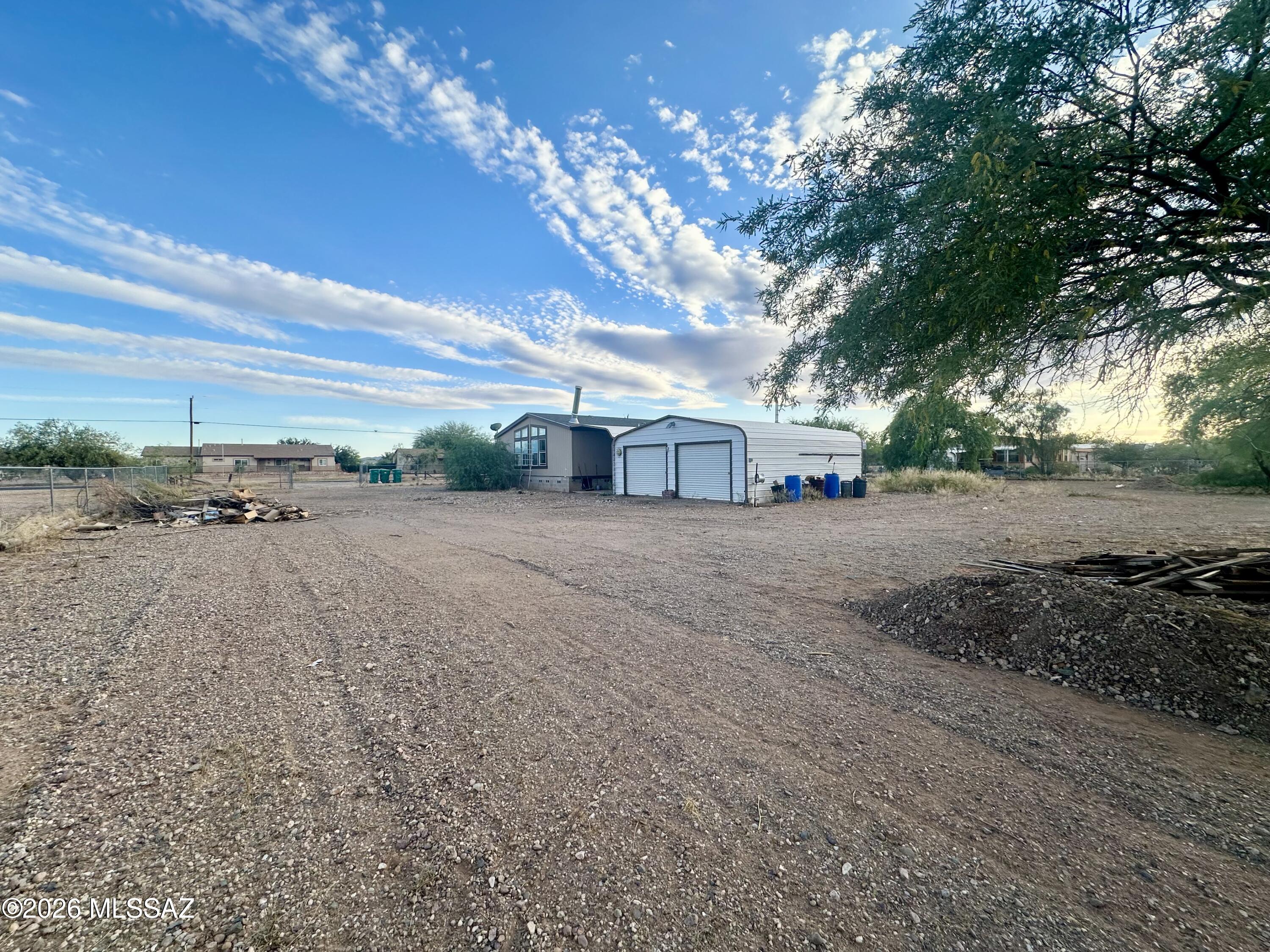 Spacious home in the heart of Avra Valley on an acre lot!  All paved roads, close to shopping, schools, & I-10! Detached garage, no HOA, and plenty of room for toys & animals! Tons of potential for investors or buyers looking to put in their own sweat equity! Almost 2300 sq ft and a HUGE bonus room that could be a family room, office, or 5th bedroom. Spacious kitchen with island and dining area. Open concept and split bedroom floorplan! Large primary suite with two closets, garden tub, and separate shower. Entire property is fenced, flat, and usable. Horse friendly with an enclosed area for horses or other animals! RV hookup for water & sewer (buyer to verify). Property is being sold as-is and priced accordingly. Needs new HVAC, some flooring, and complete refresh throughout.