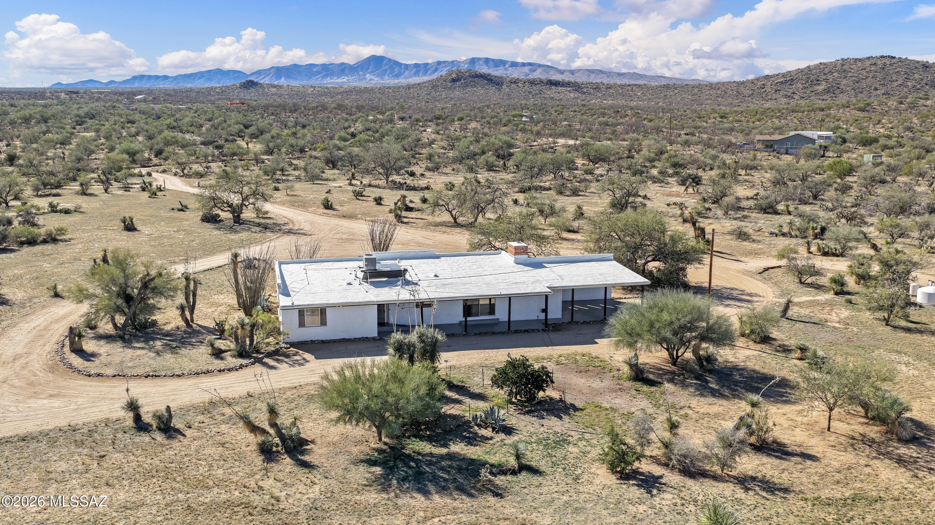 Welcome to The Ranch, where wide-open space, soul, and scenery come together. Set on 8.67 acres, this 1,756 sq ft burnt adobe ranch-style home delivers timeless character with modern updates and mountain views in every direction. Beamed ceilings, rich textures, and a wood-burning fireplace with dramatic stone anchor the home with warmth and authentic ranch charm. Inside, enjoy an updated kitchen and bathrooms, refreshed flooring, and thoughtful extras like an additional closet and bonus room off the primary suite, perfect for a retreat, exercise room, office, or creative space. Outside, mature fruit trees, expansive land, and endless possibilities await. Bring your animals, park all the toys, or build exactly what you've been dreaming of. Designed for independence and peace of mind, the