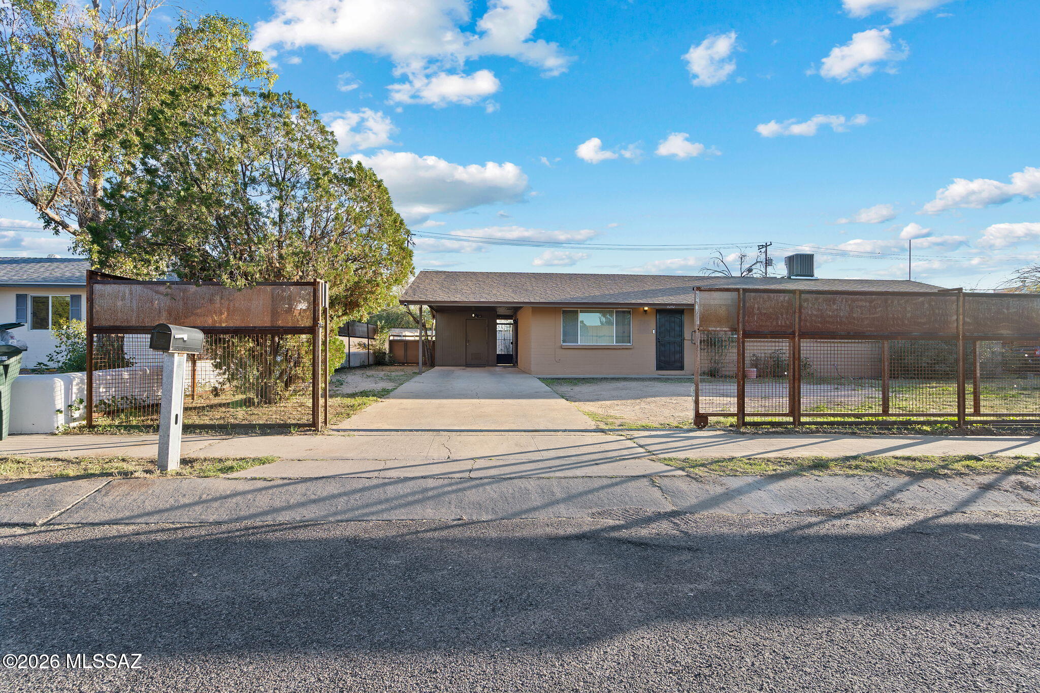 Discover the perfect blend of freedom and functionality in this solid slump-block home located in the heart of the Corbett neighborhood. Welcomed by a stylish wrought iron security gate, this residence offers peace of mind and distinct curb appeal from the moment you arrive. Featuring 3 spacious bedrooms plus a versatile den—perfect for a home office, playroom, or easy conversion into a 4th bedroom. The open floor plan creates an inviting flow, while the 2 full bathrooms ensure convenience for everyone. Step outside to your massive backyard, a true blank canvas on a 0.23-acre lot. With no HOA restrictions, a covered carport, and a huge backyard, this is a prime candidate for anyone looking to maximize value in a central location. Located centrally near schools, shopping, and dining, this home offers the space you need with the convenience you want.