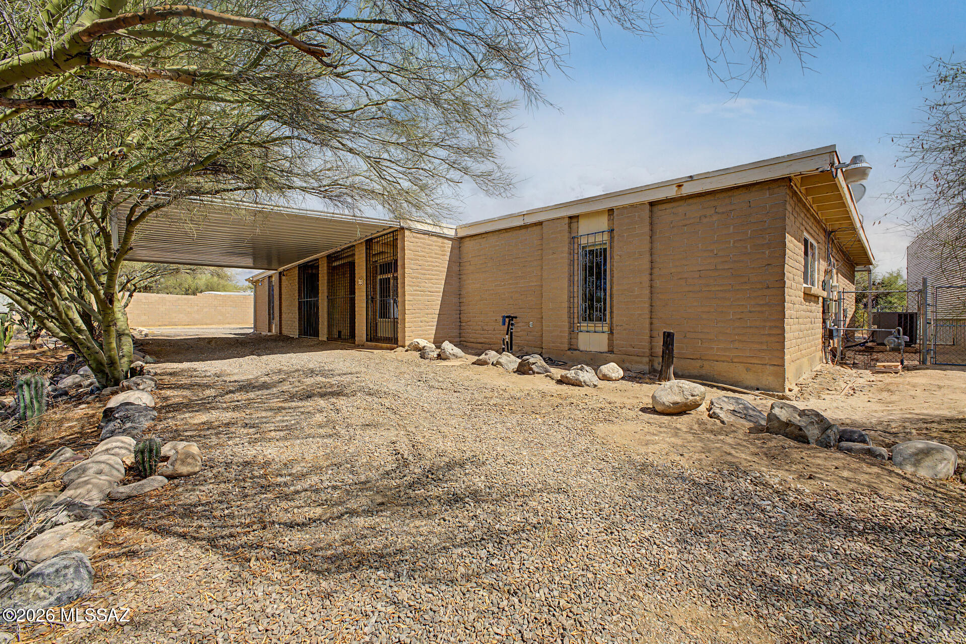 The search is over! This 3-bedroom +bonus room home sits on almost a 1 acre lot. Enter through the double doors to find a welcoming living room with a cozy fireplace that flows seamlessly into the dining area. Saltillo tile flooring in main living area. Skylights keeps it feeling light & bright and brick walls are the designer touch. The kitchen has a large center island, and a breakfast nook. Primary bedroom with private bathroom.  Adding to the house's versatility is a dedicated den or office with it's own entrance.  Spacious backyard with an enclosed, covered patio and sparkling pool. Lots of fruit bearing trees, Meyer lemon, lime and orange.   Big bonus-the RV garage with complete hook-up capabilities (sewer, electric & water) plus a 2 car garage, lots of parking for friends & family