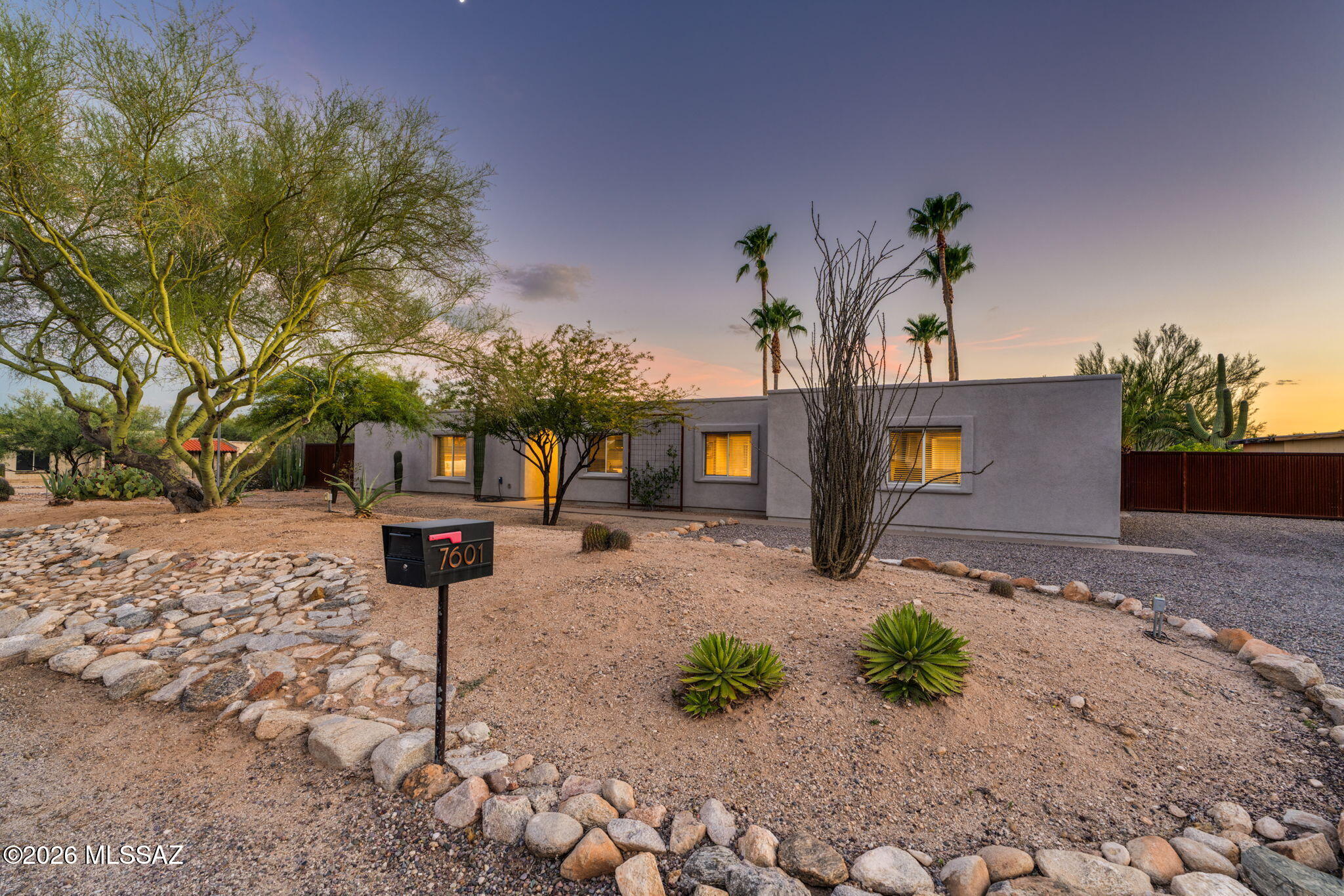 Truly a one-of-a-kind property in the highly sought-after Casas Adobes community-offering the perfect blend of luxury, versatility, and functionality on a fully enclosed 0.71-acre lot with no HOA. Completely remodeled within the last five years, both the main home and detached guest house showcase beautiful, high-end finishes, an open-concept design, and luxury flooring throughout. Step outside to your own private backyard oasis designed for entertaining. Enjoy the expansive turf lawn, sparkling pool, mature citrus trees, covered patio, and multiple gathering spaces, including a cozy firepit area- perfect for relaxing or hosting family and friends year-round. The detached guest house is a standout feature, complete with its own kitchen, full bathroom, and loft, making it ideal for multi- generational living, long-term guests, a private office, or entertaining opportunities. The impressive 36' x 30' fully insulated, temperature-controlled shop is equipped with 200-amp electrical service and is complemented by its own separately enclosed shop yard with a 20-foot gate for easy access. RV owners will appreciate the dedicated RV carport with full hookups, including power, water, and waste connections, making travel preparation effortless. Additional thoughtful features include two separate water meters- one serving the home and another dedicated to the pool and irrigation- helping reduce utility costs. Major system updates completed within the last five years provide peace of mind, including a roof re-coat, pool resurfacing, two new HVAC systems, and a new water heater. Ideally located with convenient access to Northwest Tucson, the Catalina Foothills, and Oro Valley amenities, this exceptional property is also situated within the highly acclaimed Amphitheater School District. Properties that combine a beautifully remodeled home, private guest quarters, an incredible workshop, RV amenities, and resort-style outdoor living on nearly three-quarters of an acre-with no HOA-are exceptionally rare. This is a one-of-a-kind opportunity to own a property that truly has it all.