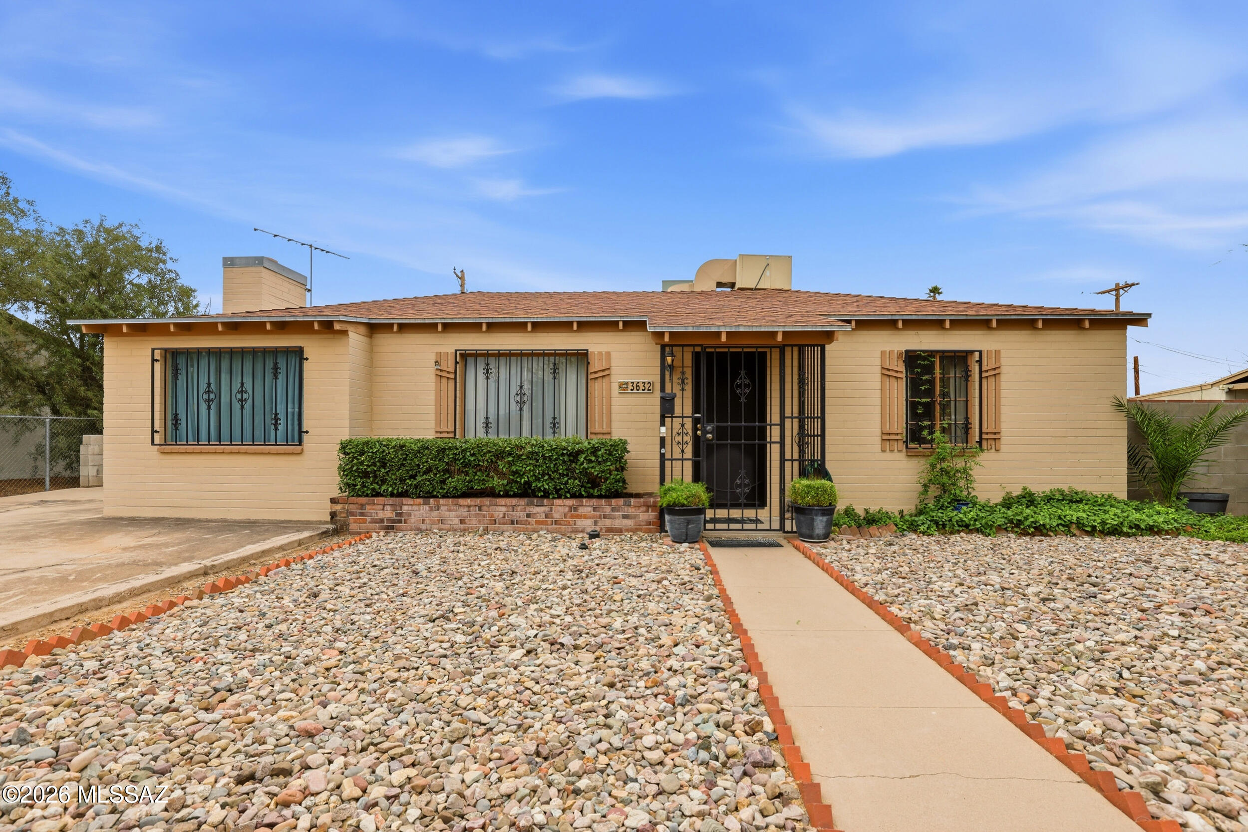 Welcome to this thoughtfully maintained home situated on a large lot in the heart of Tucson. Designed with flexibility in mind, the home features multiple living areas that provide ample space. At the center of the home, the kitchen serves as a warm and functional gathering space with easy access to the surrounding living areas. Thoughtful upgrades add both value and peace of mind, including updated water lines and a relocated gas line with no underground gas piping. The recently remodeled bathroom features a dedicated dressing and vanity area. A spacious laundry room is equipped with abundant cabinetry and counter space. Outside, the expansive lot offers endless possibilities with room to expand. An exceptional option for both owner-occupants and investors alike.