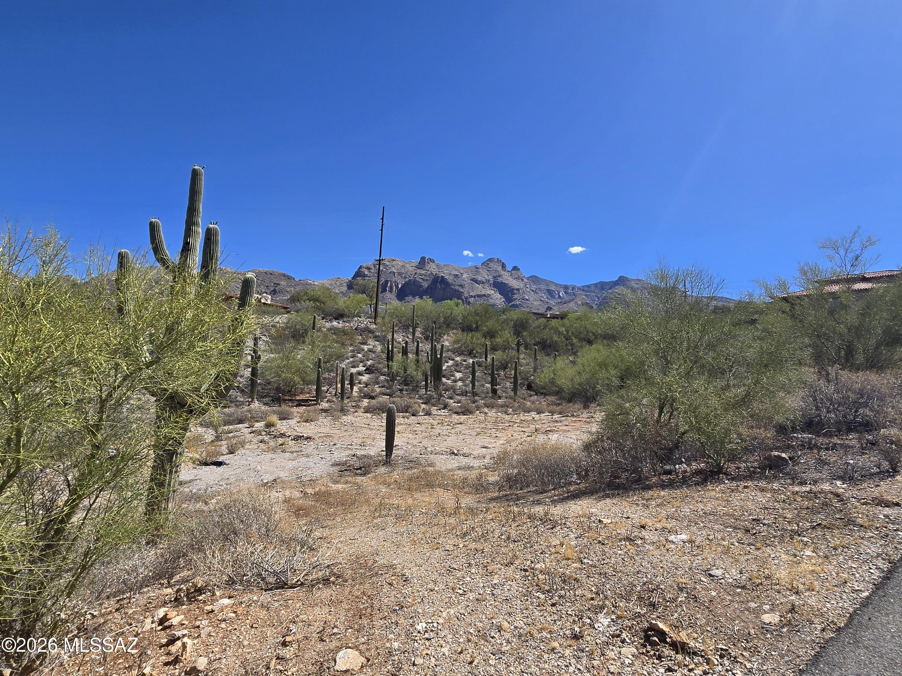 Build your dream home in the heart of the Foothills on this stunning 1+ acre cul-de-sac homesite with several stunning Saguaros and desert beauty. Enjoy the perfect blend of privacy and scenery with breathtaking mountain views and sparkling city lights by night. A rare opportunity to own a slice of Arizona paradise with unforgettable sunsets and incredible natural surroundings.
Lot has already been approved through Pima County HDZ design process including HDZ grading permit, alternative septic design and permit, water meter installed with impact fees paid, and clearing with ~80% grading completed. Seller also has approved permits for a 4,266sqft 4Bed/4 Full Bath 2 Half Bath home (all bedrooms have ensuite bathrooms).