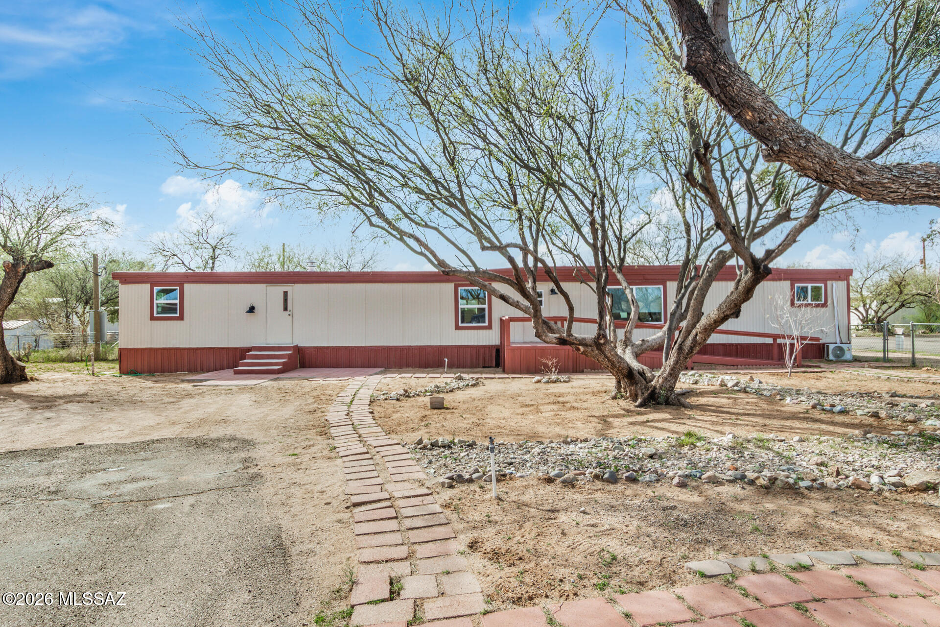 Light-filled 3-bedroom, 2-bath manufactured home in the peaceful Santa Rita Heights Mobile Home Park on leasehold land. The thoughtful split floorplan offers privacy and a generous living area drenched in natural light. The kitchen provides ample cabinetry and flows to the dining area for easy everyday living. Primary suite with a private bath; all bedrooms are well-sized. Outdoors features low-maintenance desert landscaping, mountain views, and a front entry ramp for added accessibility. Parking includes a dedicated space on the north side plus a multi-vehicle driveway. Well cared for with recent updates throughout and move-in ready.