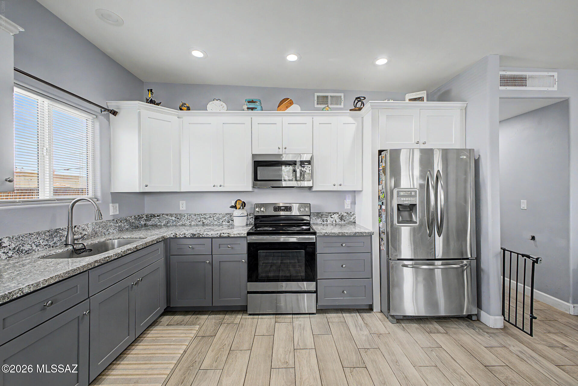Ask about 0% down financing available for qualified buyers! This 2023-built home combines modern design with everyday convenience, just minutes from Downtown Tucson and I-10. The bright, open floor plan features ceramic tile flooring throughout, granite countertops, upgraded cabinetry, recessed lighting, and ceiling fans. Situated on a desirable corner lot, the property offers added privacy with a newly installed front metal gate and a spacious yard ready for entertaining, pets, or future customization.