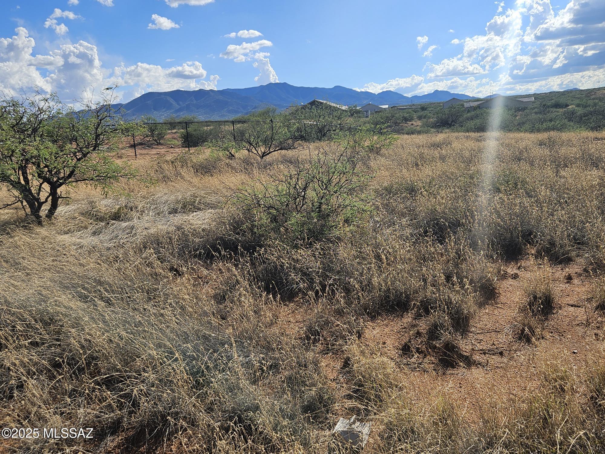 This lot is situated in the heart of Benson growth corridor just south of Interstate 10 with spectacular views of the Dragoons, Whetstone and Rincon mountains in addition to the San Pedro Valley, all approximately 40 minutes east of Tucson.
This Cottonwood Highlands is custom home lot finished subdivision.  The original historic sales in the subdivision averaged over $100,000 per lot.  Deed restrictions exist to maximize the views and privacy of the homesites.  The HOA is not active but is noted for road maintenance purposes.
Property is border by portions of the Vigneto Villages planned community development holdings and projected for 28,000 homes with numerous village centers, golf courses and trails. 2 additional lots available