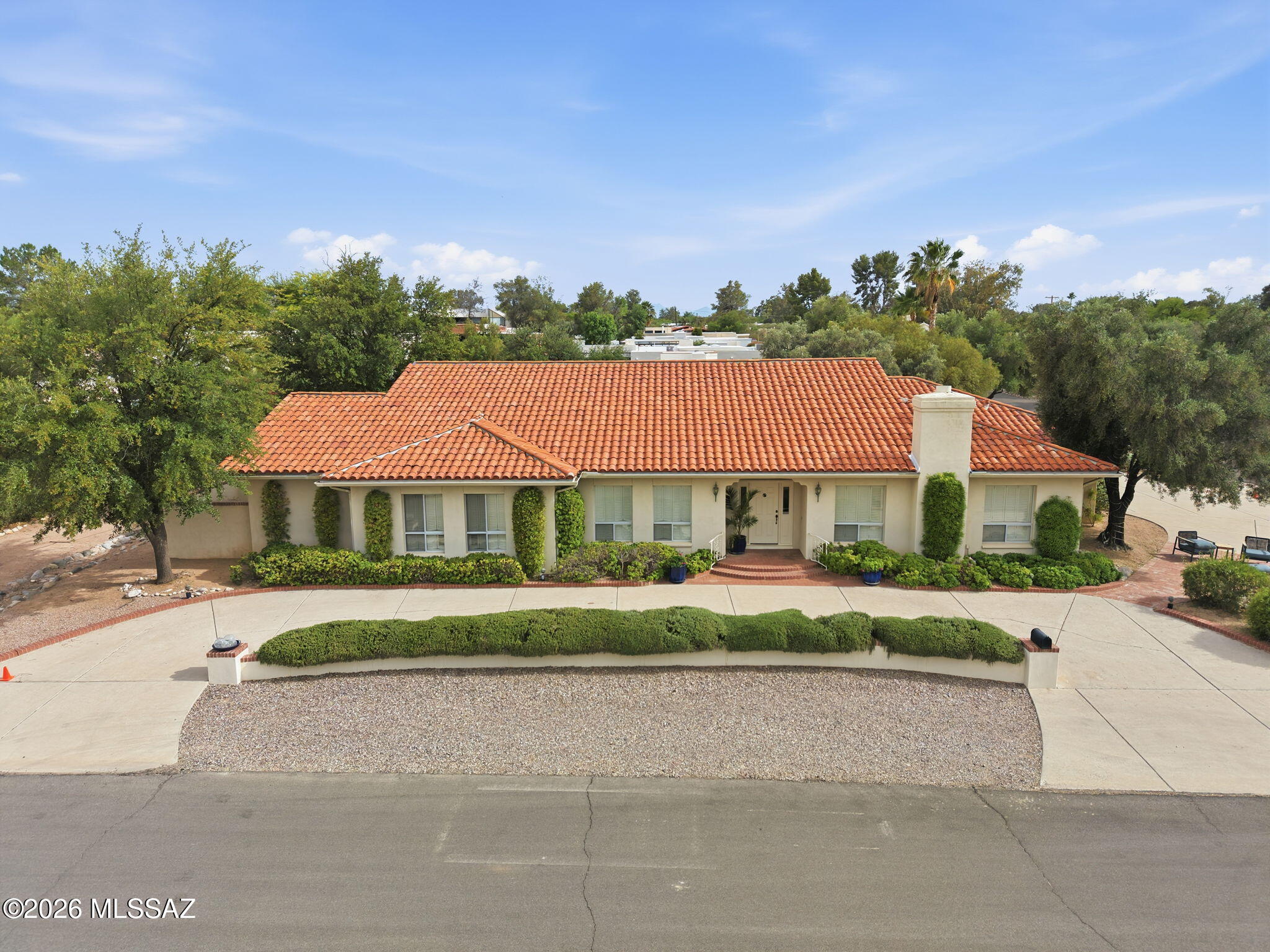 NEW PRICING and FRESHLY PAINTED ROOMS make this timeless and elegant Tucson Country Club home move-in ready. Thoughtfully designed with soaring ceilings, distinctive architectural details and AMAZING MOUNTAIN VIEWS. Rich wood flooring flows through the hallways, formal dining room, and den/bedroom. This home includes generously sized rooms accented with built-in bookcases and classic plantation shutters. The spacious primary suite is a true retreat  with a luxurious bath featuring a soaking tub, walk-in shower, and expansive walk-in closet. The generous kitchen has been updated with new paint, cooktop, refrigerator, and dishwasher. A charming breakfast nook provides the perfect space for casual dining or morning coffee. The rear patio and yard creates a private oasis for relaxing and entertaining. Pool plans and installation costs are available for those seeking to create the ultimate luxury backyard experience. This gem of a property is just a short walk to the Tucson Country Club's dining, golf, tennis, and pool facilities.