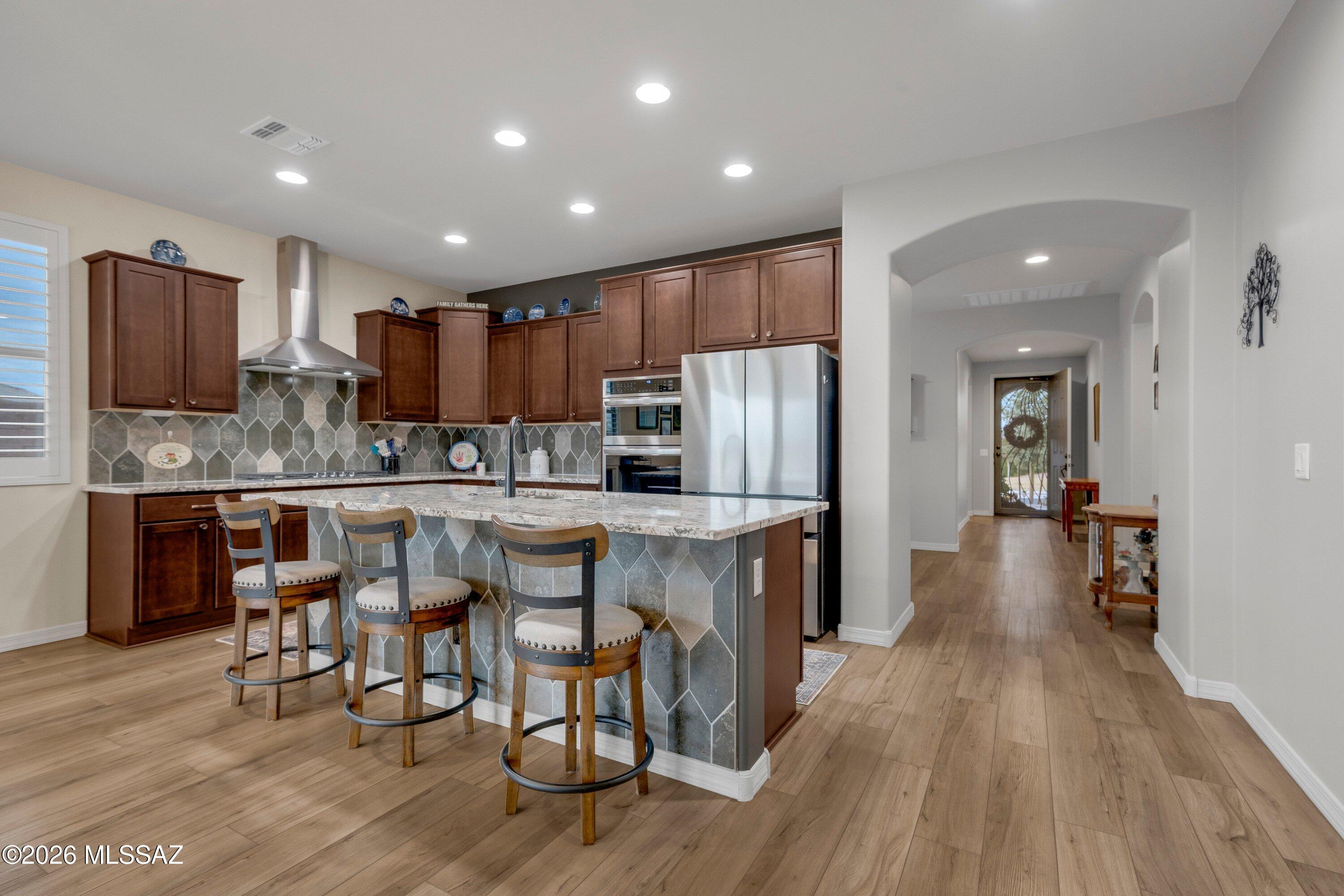 Why wait for new construction when this highly upgraded 2023 home is move-in ready and waiting for you? Situated on a desirable corner lot in the sought-after Rocking K community, this thoughtfully designed home combines modern finishes, functional living spaces, and low-maintenance outdoor living with stunning mountain views. Step inside to soaring 9-foot ceilings, a welcoming formal foyer, abundant natural light, and a desirable split-bedroom floor plan. A versatile flex space sits between the guest bedrooms and executive kitchen, offering endless possibilities as a home office, formal dining room, playroom, media room, or hobby space. At the heart of the home, the executive kitchen was designed for both entertaining and everyday living. Featuring granite countertops, a large center island, walk-in pantry, convection oven, 5-burner gas range, and ample workspace, it seamlessly connects to the spacious family room, creating the perfect gathering place for family and friends.
The private primary suite offers a peaceful retreat complete with mountain views, a spa-inspired bathroom featuring a walk-in shower, dual vanities, and an expansive walk-in closet with direct access to the oversized laundry room. Complete with a utility sink, additional storage, and space for an extra refrigerator or freezer, convenience is built into every detail. Outside, enjoy professionally designed low-maintenance landscaping with pavers, artificial turf, and inviting outdoor spaces perfect for relaxing or entertaining. The upgraded two-car garage features epoxy flooring, additional lighting, and enhanced storage through the hobby package. Additional upgrades include Hunter Douglas window coverings, plantation shutters throughout, Hampton Bay ceiling fans, gutters, and countless thoughtful enhancements that add both beauty and functionality. With a newer roof, HVAC system, water heater, and major components all just a few years old, this home offers the peace of mind today's buyers are looking for. Beautifully maintained, thoughtfully upgraded, and truly move-in ready--this is the Rocking K lifestyle you've been waiting for.