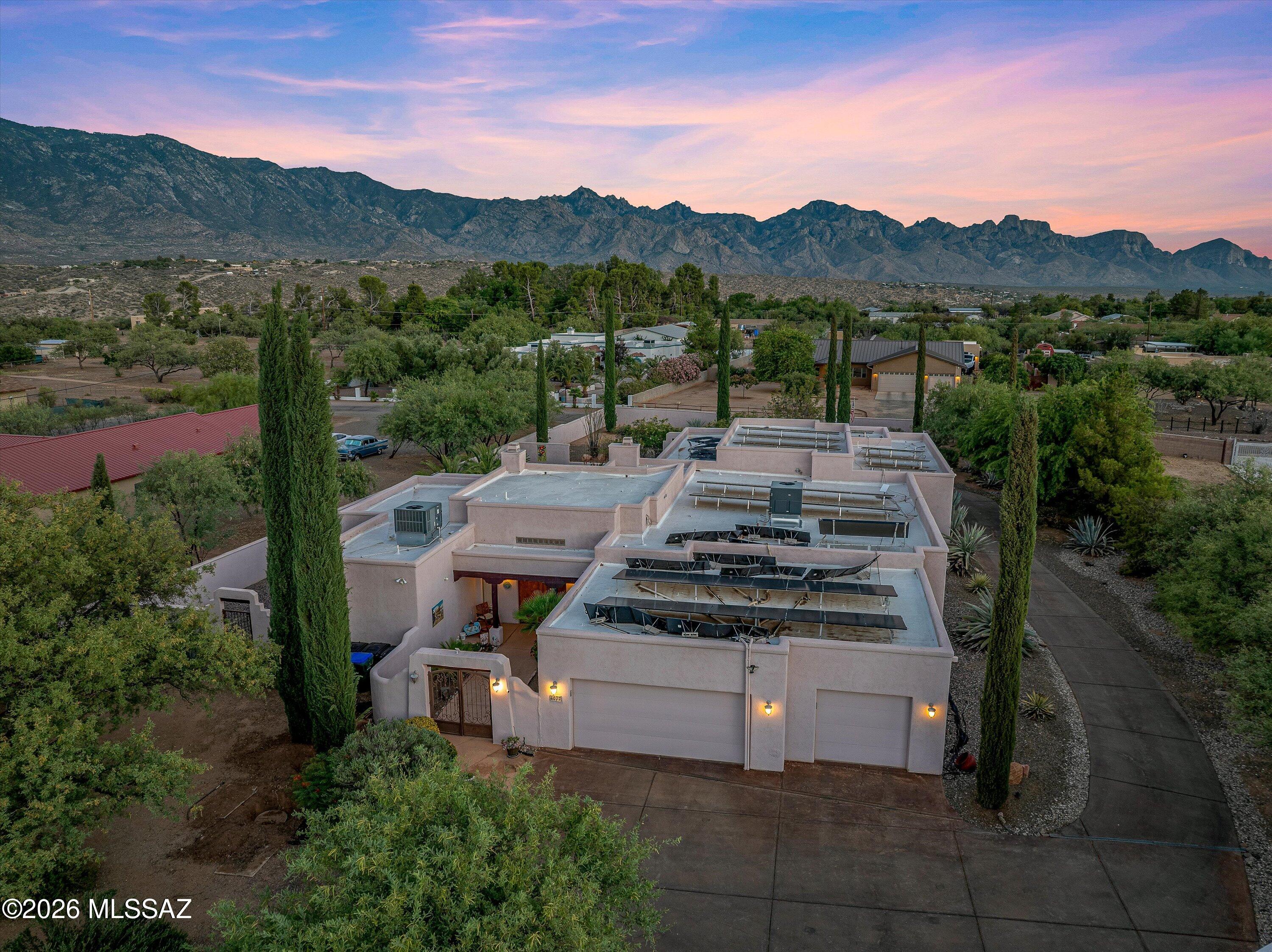 Rare opportunity to own this Southwest-style estate with 5 bedrooms, 5 baths, a 5-car garage, on one acre with NO HOA! Designed with a split floor plan for multigenerational living, it features three en-suite bedrooms, theater room, recreation room, exercise room, office, and custom alder wood kitchen with granite countertops and wet bar. Breathtaking Catalina Mountain views that grace nearly every room. Step outside to your private oasis. Saltwater pool, waterfall, hot tub, outdoor kitchen, built-in-grill, screened porch, courtyard fountain, fruit trees, vegetable garden, and Mexican Talavera tile, oversized paid-off solar at COE, a few gated accesses. Schedule your private showing today!