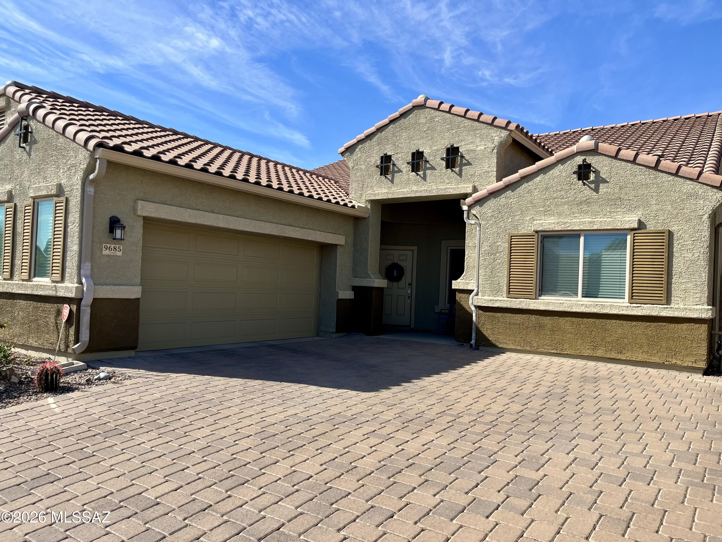 Say goodbye to builder-grade basics and say hello to high-end, custom design elements in this beautifully maintained home in Saguaro Bloom. From the moment you step inside, you'll notice the difference; coffered ceilings welcome you at the entry and set the tone for a home that truly shows like a model home. You will love the soaring 11' ceilings throughout. Just off the front door, the versatile den provides an amazing bonus space. The laundry room is both functional and thoughtfully designed with built-in cabinetry and an additional freezer that conveys with the home. At the heart of the home the kitchen is designed for both everyday living and entertaining. You'll love the granite countertops, oversized island with storage on both sides, walk-in pantry, stainless steel appliances, and a stunning backsplash that ties the space together beautifully. The peaceful primary retreat offers a quiet place to unwind and features its own private door leading directly to the backyard oasis.
 Step outside to a truly stunning outdoor space with no rear neighbors, breathtaking mountain views, turf, pavers, backyard lighting, a cozy fire pit, and a hot tub. This is truly the perfect setup for enjoying Arizona evenings. Back inside two additional bedrooms are thoughtfully positioned around a spacious teen retreat. This bonus area is incredibly versatile and could easily become another TV room, craft space, playroom, or additional office; the possibilities are endless. Living in Saguaro Bloom means access to an array of community amenities including parks, pools, a basketball court, walking and biking trails, and so much more. There's a reason so many individuals are making the move to Saguaro Bloom- come and see for yourself!