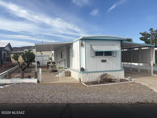 Nice well cared for furnished home with a bedroom and bathroom at each end of the home. Large covered patio on west side with golf cart hookup. Flooring replaced with nice laminate solid surface flooring. Windows have been replaced. Open kitchen to living room with island in kitchen. Rheem central AC unit installed in 2017. There is a shed on each side of home and a gate across the driveway.  Located in an active 55+ community, the HOA fee includes unlimited golf, tennis, pickleball, shuffleboard, pools, spa, fitness center, trash service, and much more. Best of all--you own the land. This is carefree living at its finest.